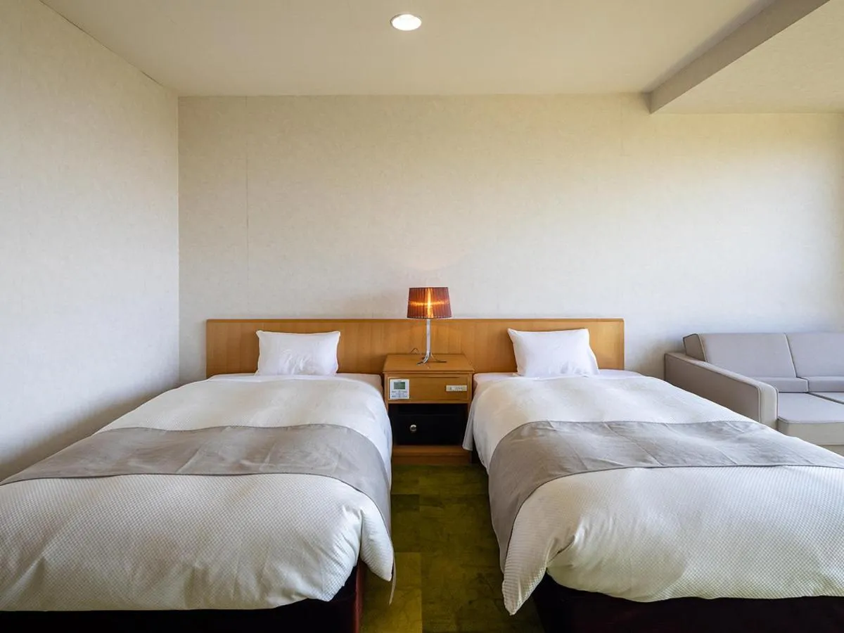 Bed in Ooedo Onsen Monogatari Amakusa Hotel Kameya