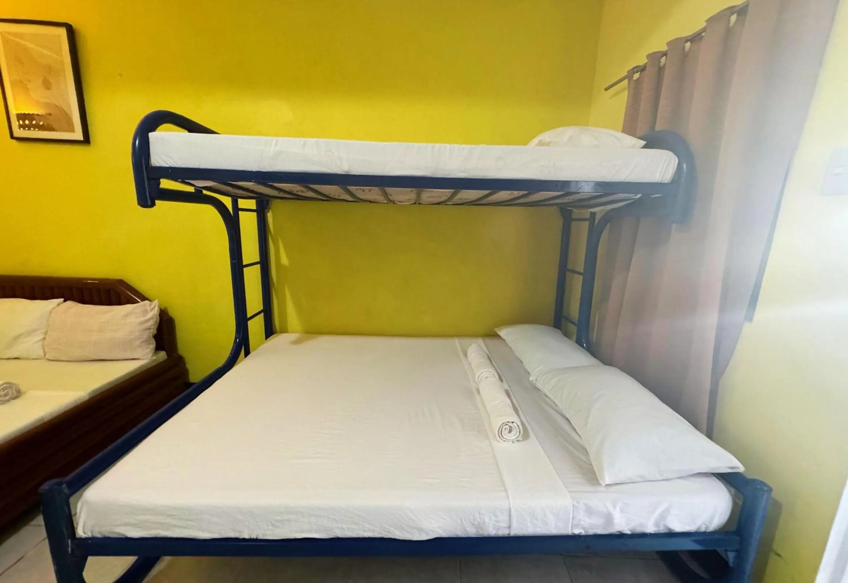 Bed in Simons Heritage Resort Puerto Galera