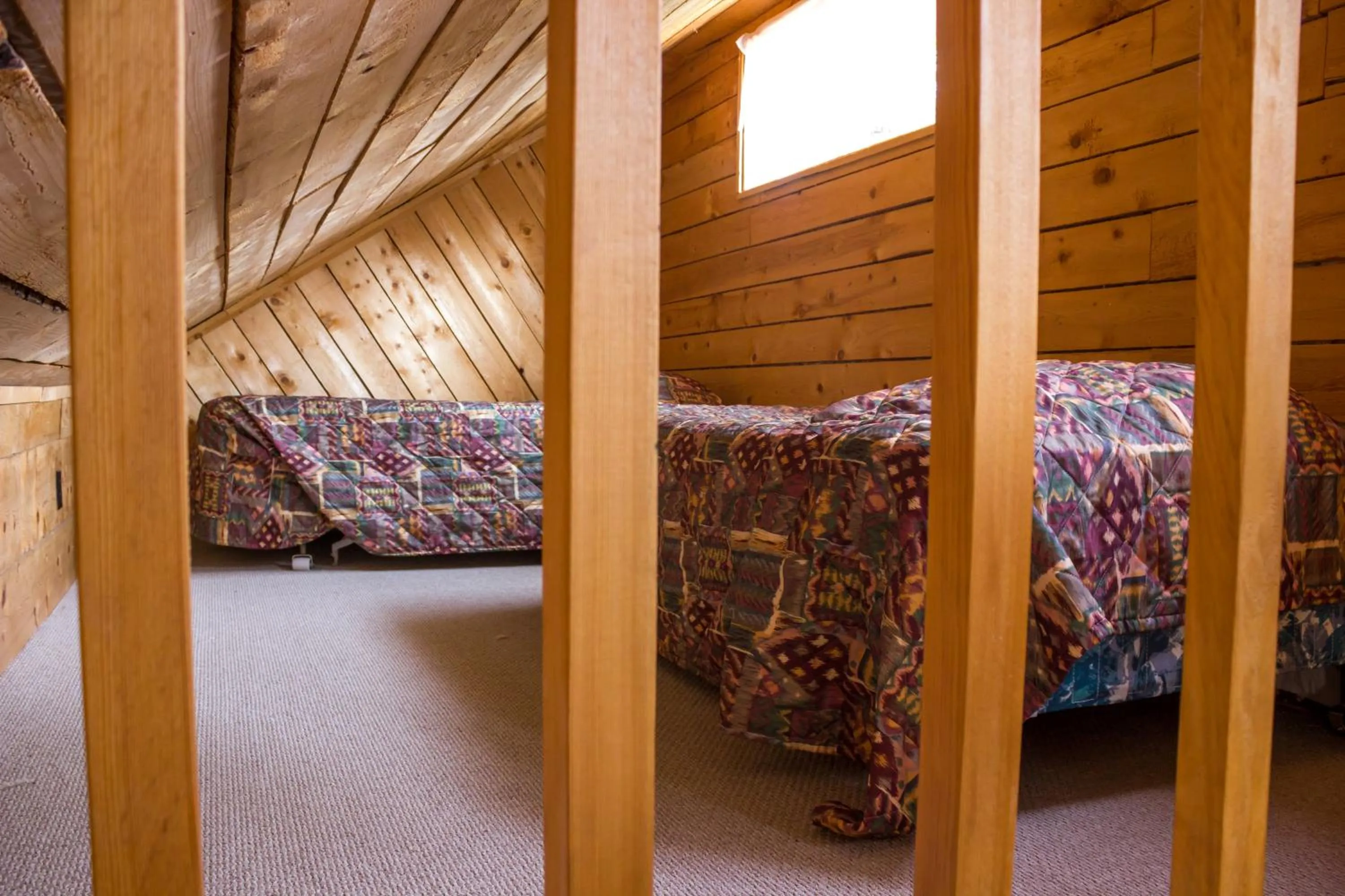 Bed in Midnight Sun Log Cabins