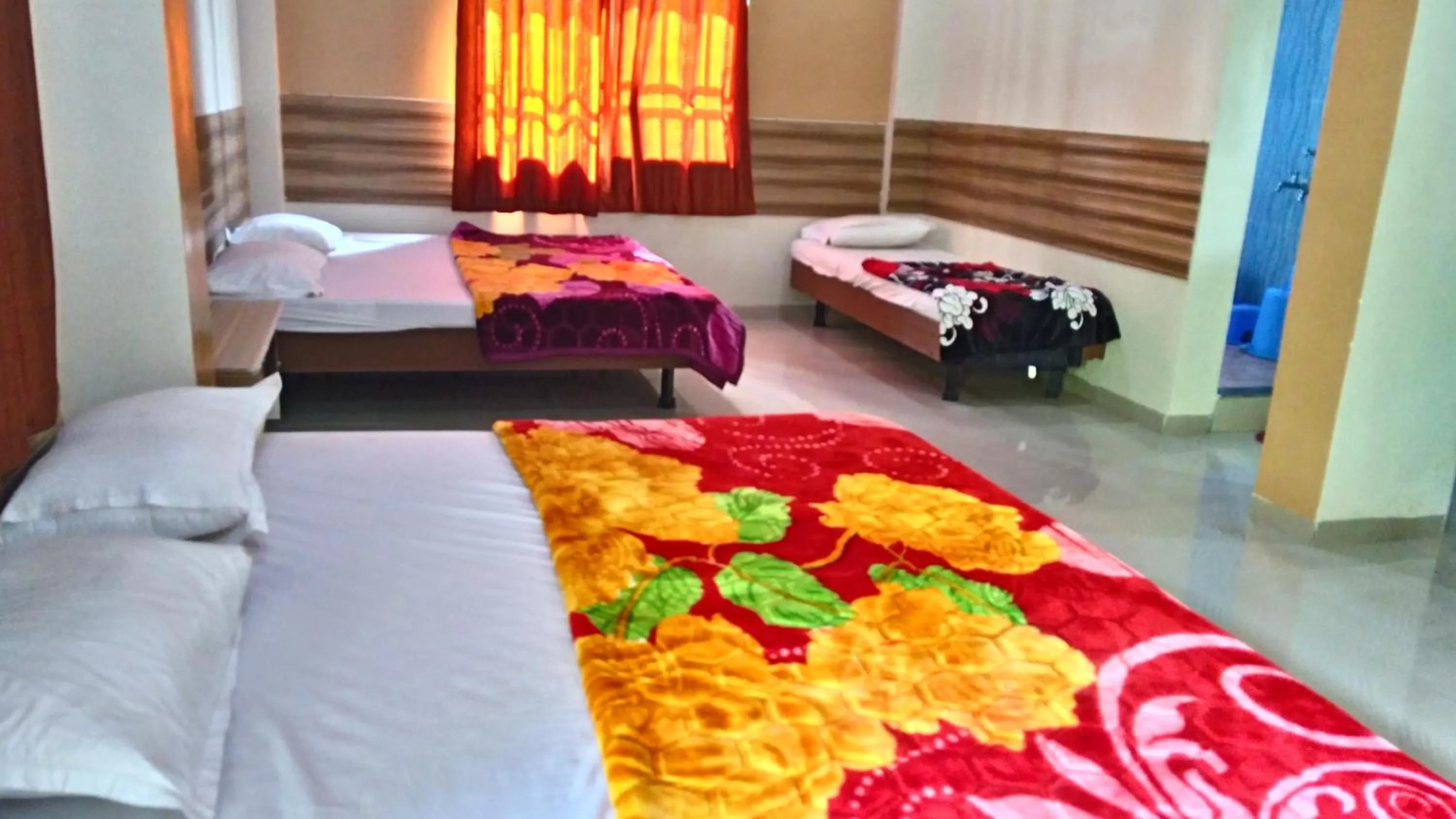 Bed in Sai Atithi Resort