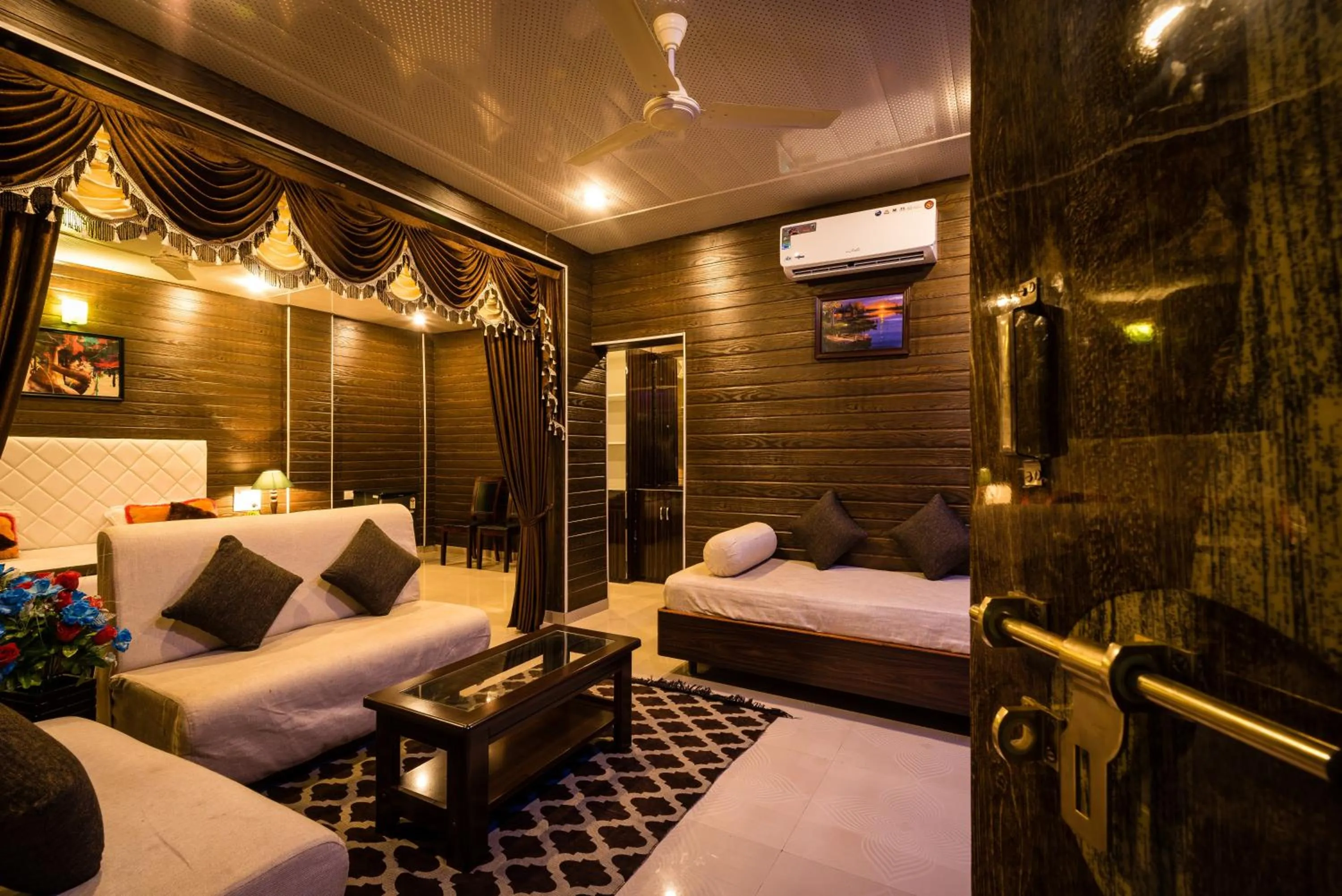 Seating area, Bed in Sai Atithi Resort