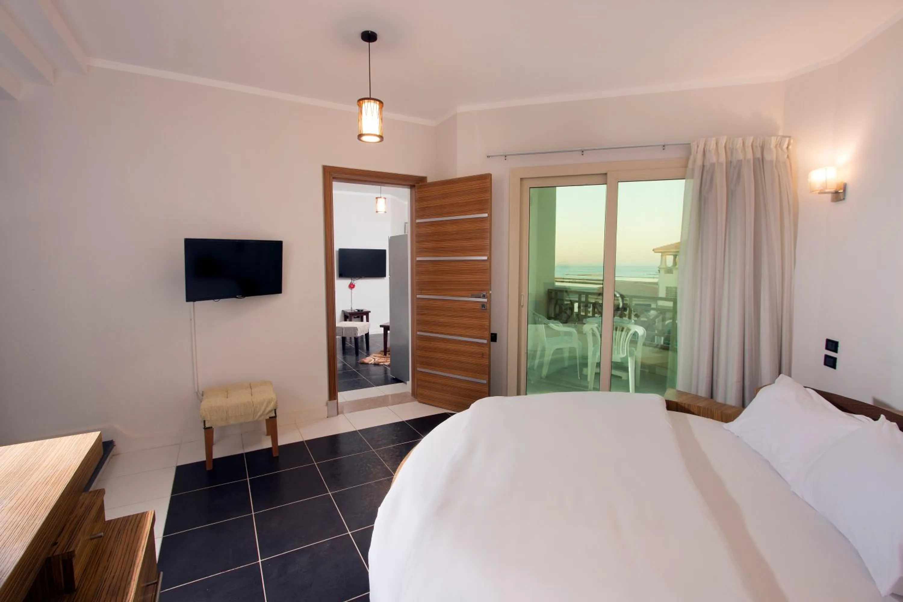 Communal lounge/ TV room, Bed in Royal Beach Serviced Apartments