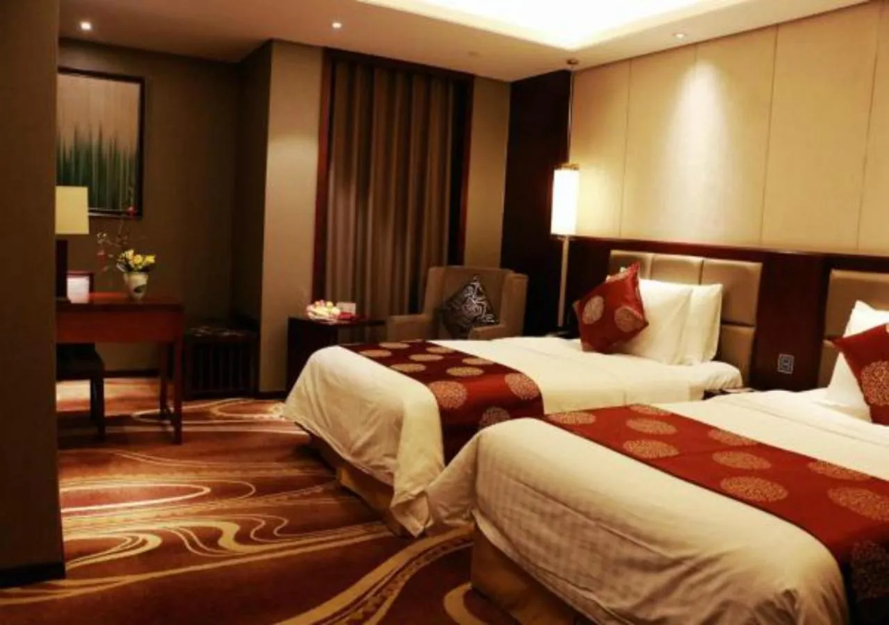 Bed in New Century Grand Hotel