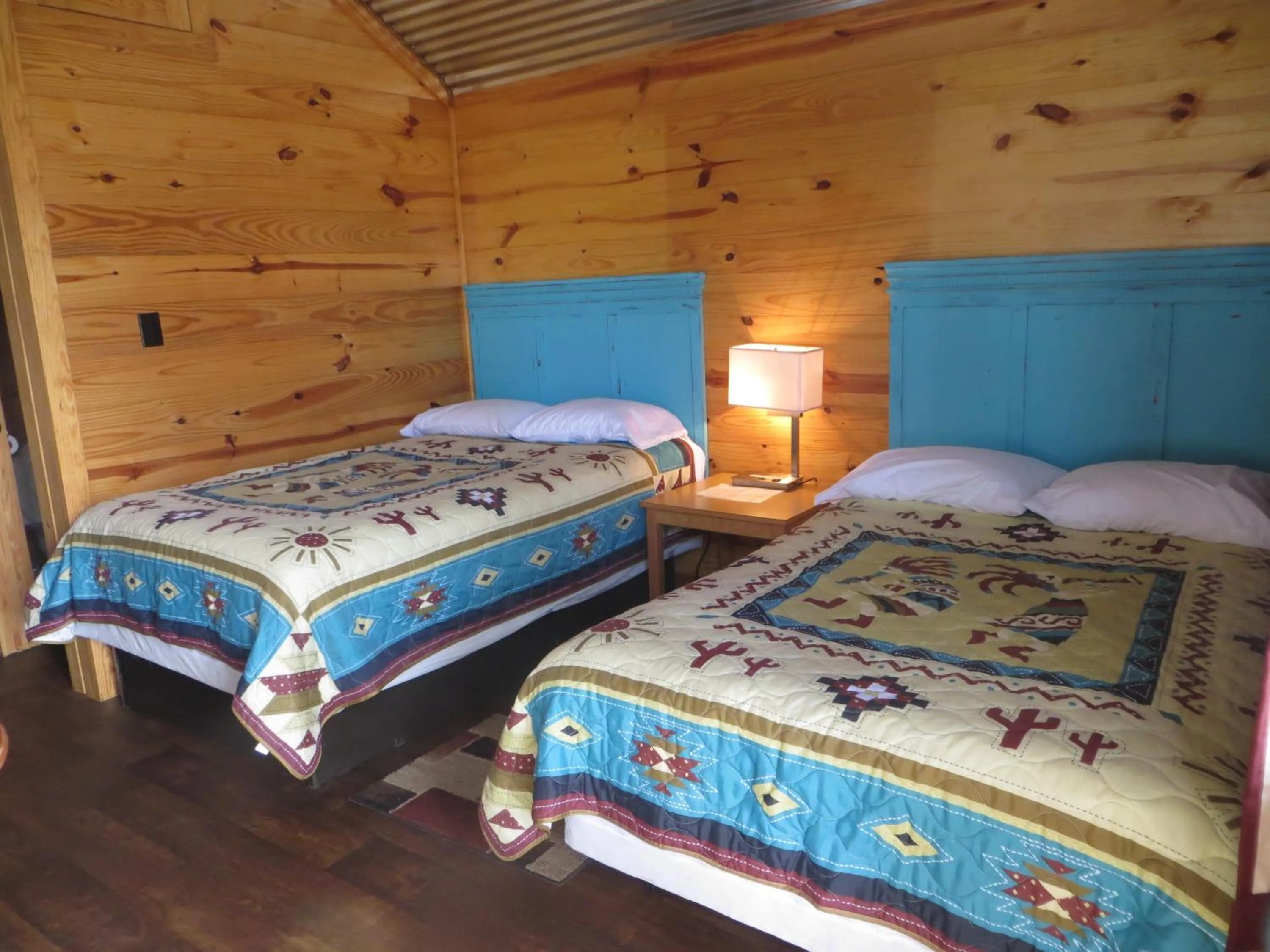 Bed in All Tucked Inn Cabins