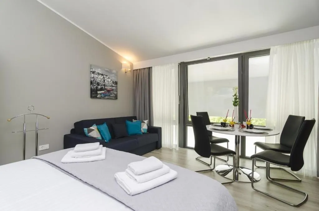 Seating area, Bed in Apartments ZoomZoom