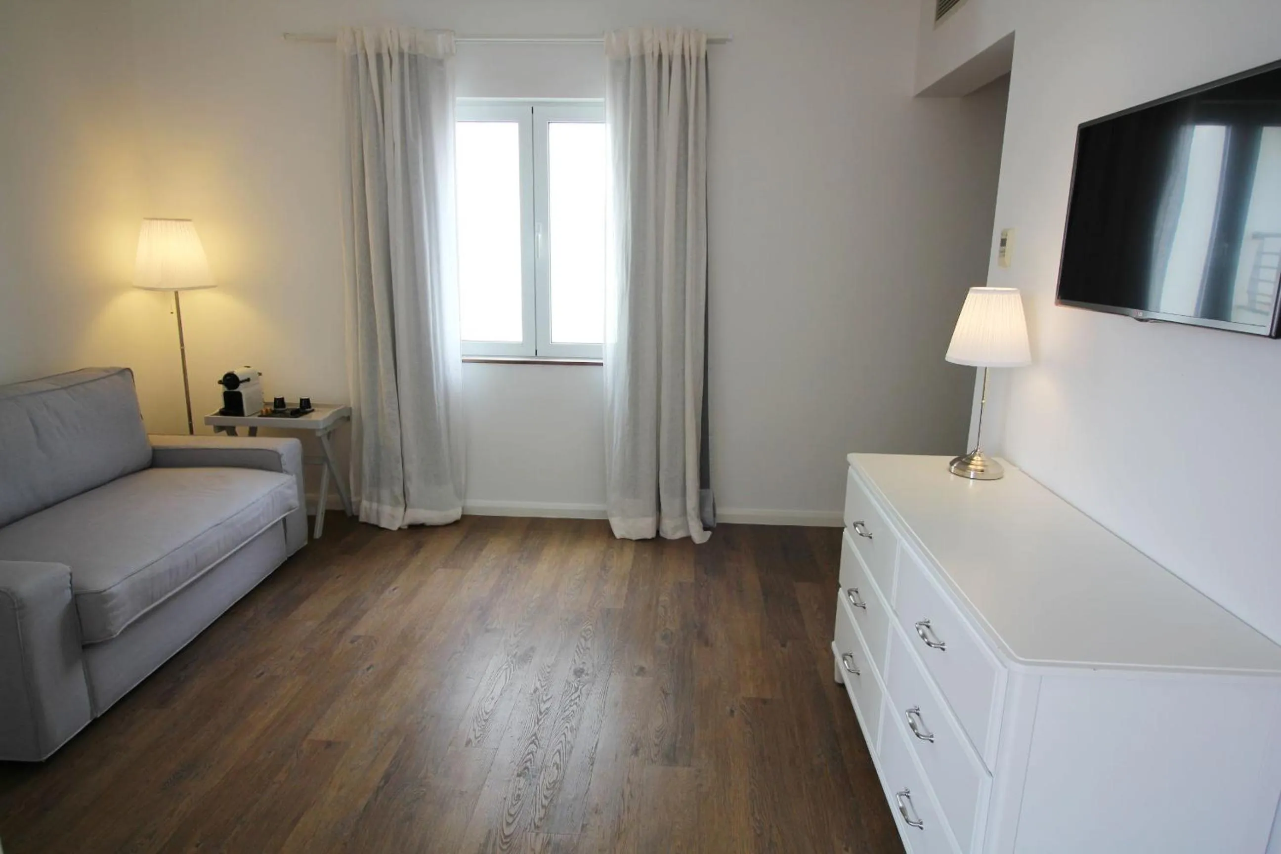 Bedroom in Vinha da Areia Beach Hotel
