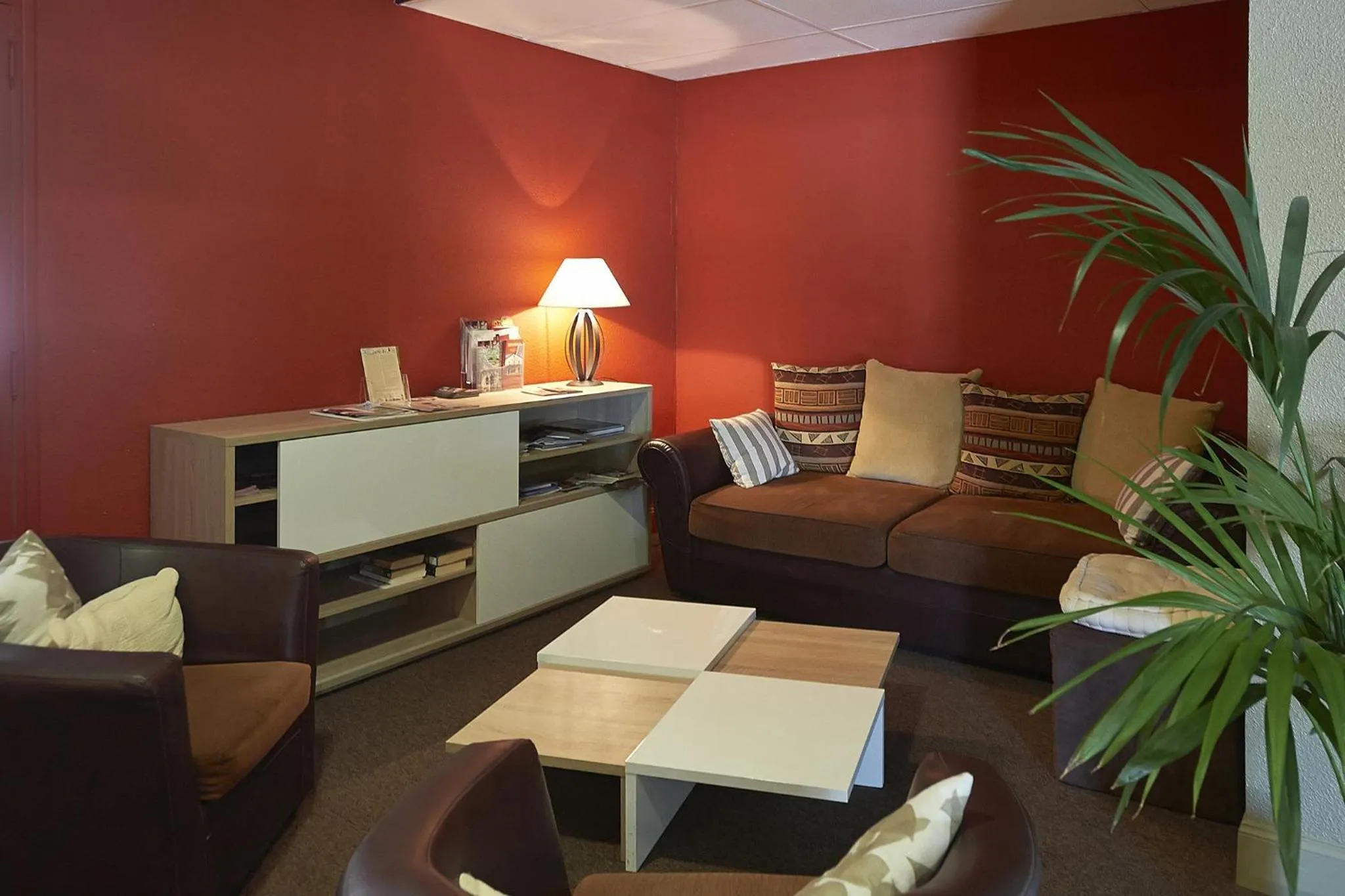 Communal lounge/ TV room in Cit'Hotel Les Alizés