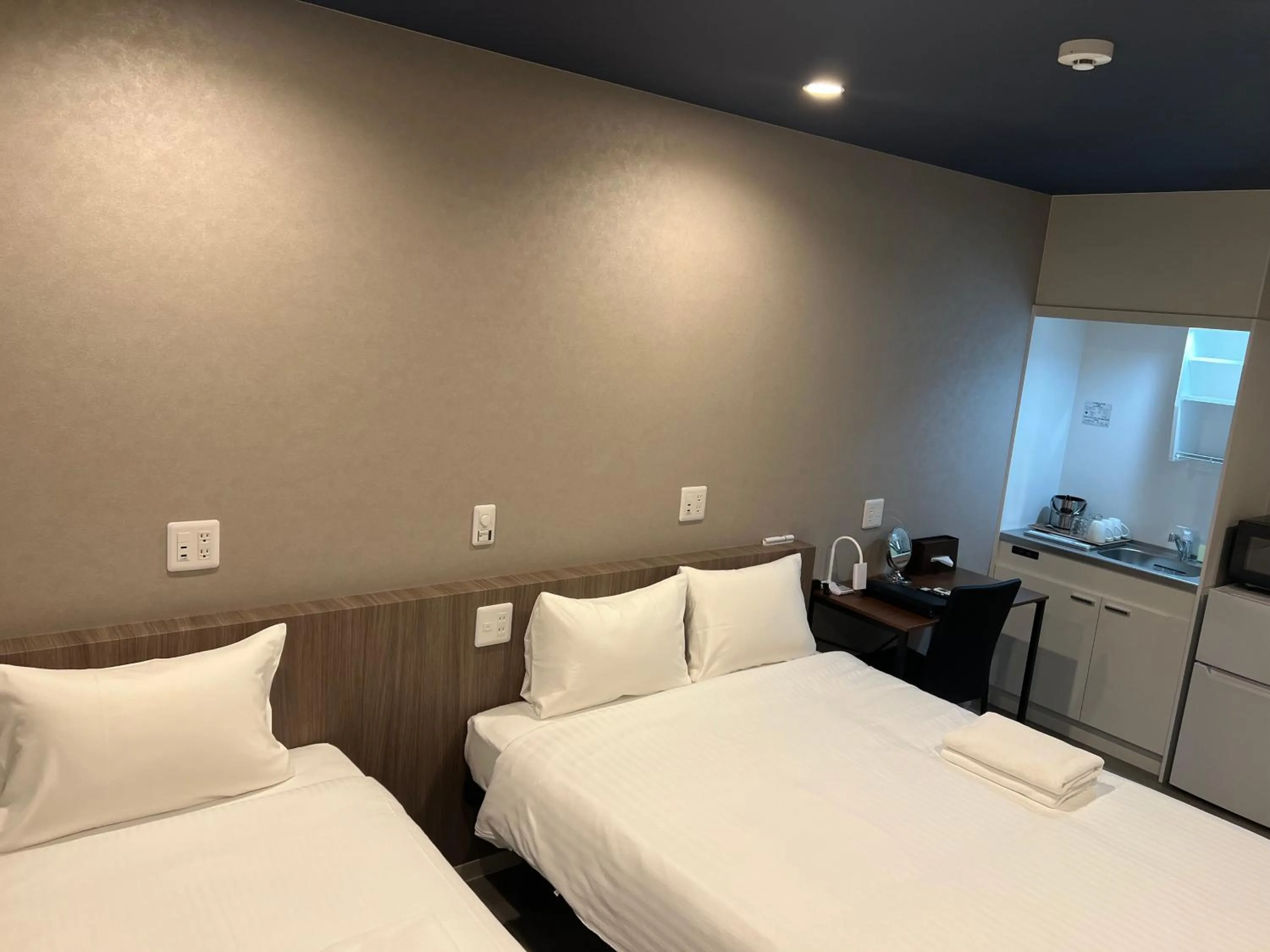 Bed in Living Inn Asahibashiekimae Premier