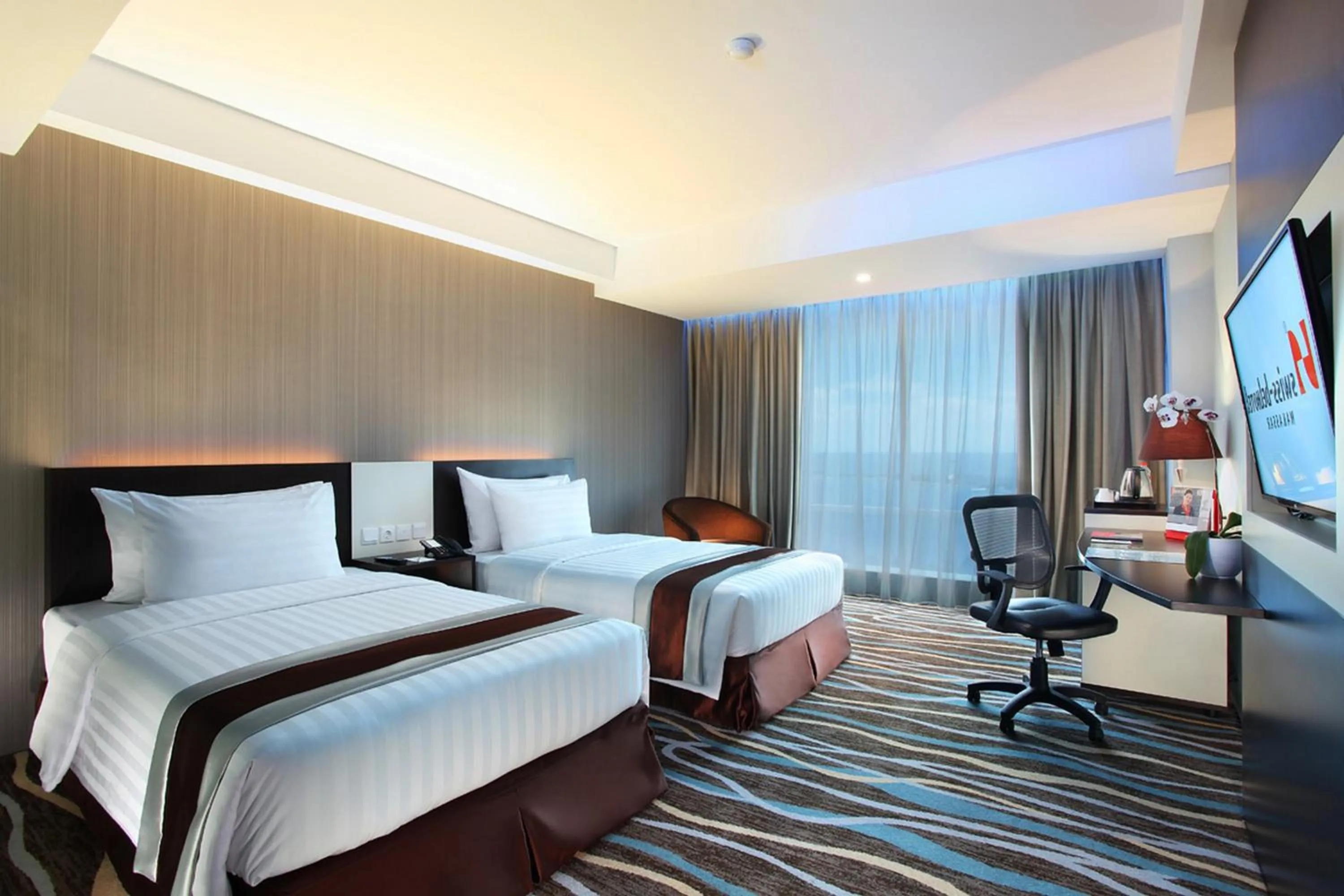 Bed in Swiss-Belhotel Makassar