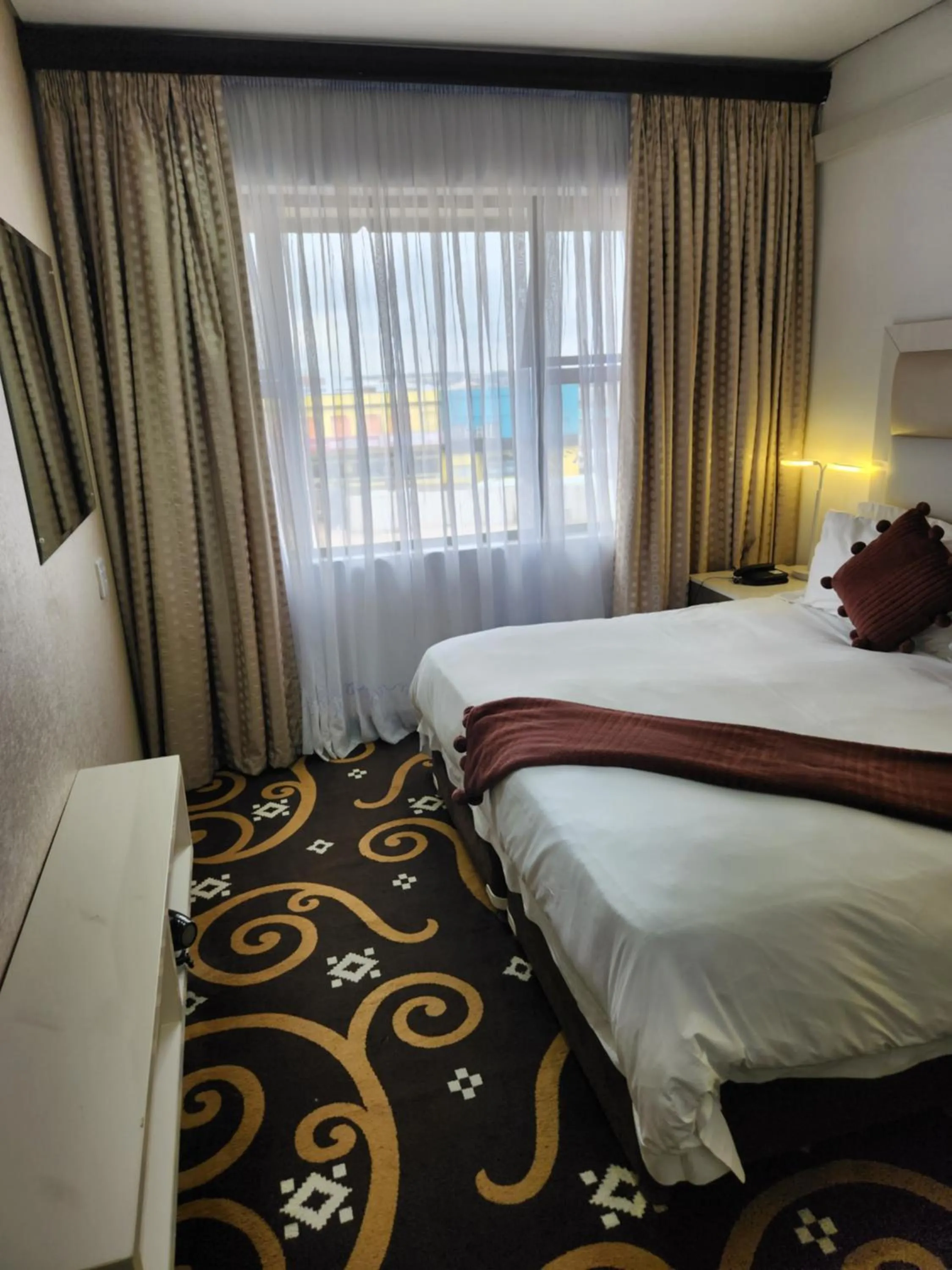 Bed in Palm Continental Hotel