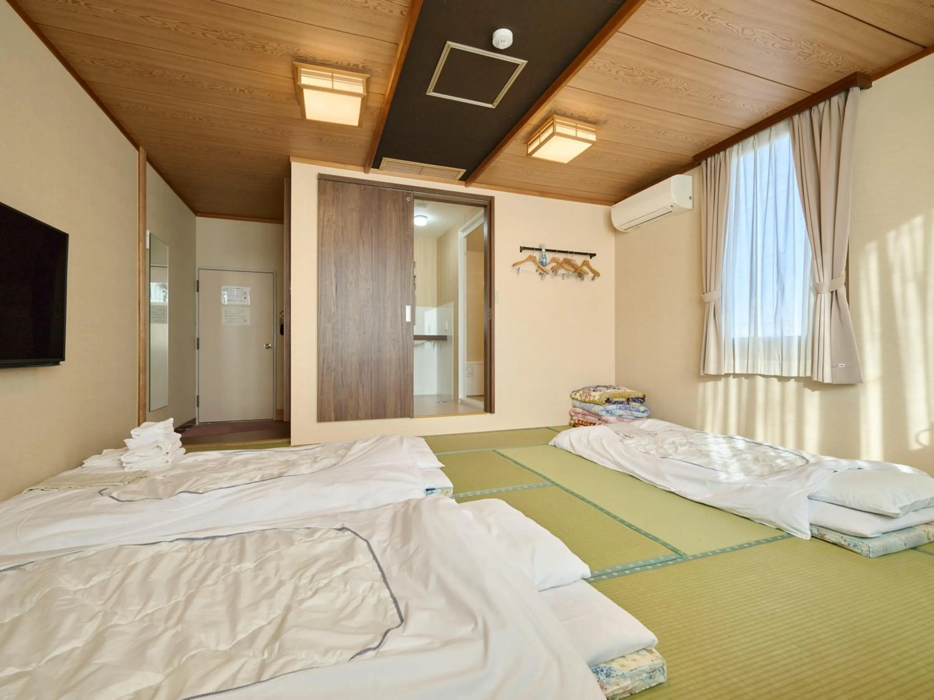 Photo of the whole room, Bed in Okasan Hotel