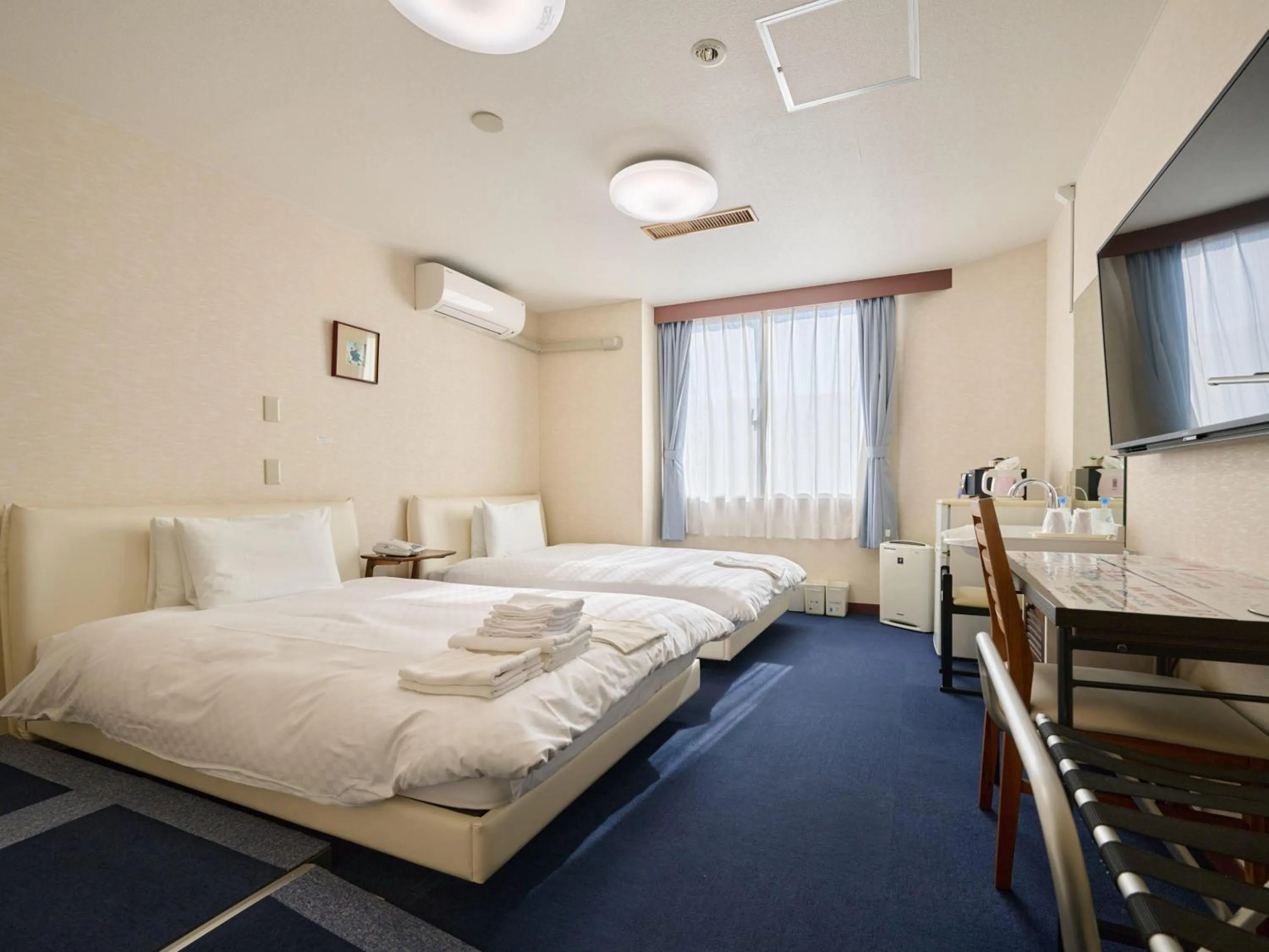 Photo of the whole room, Bed in Okasan Hotel