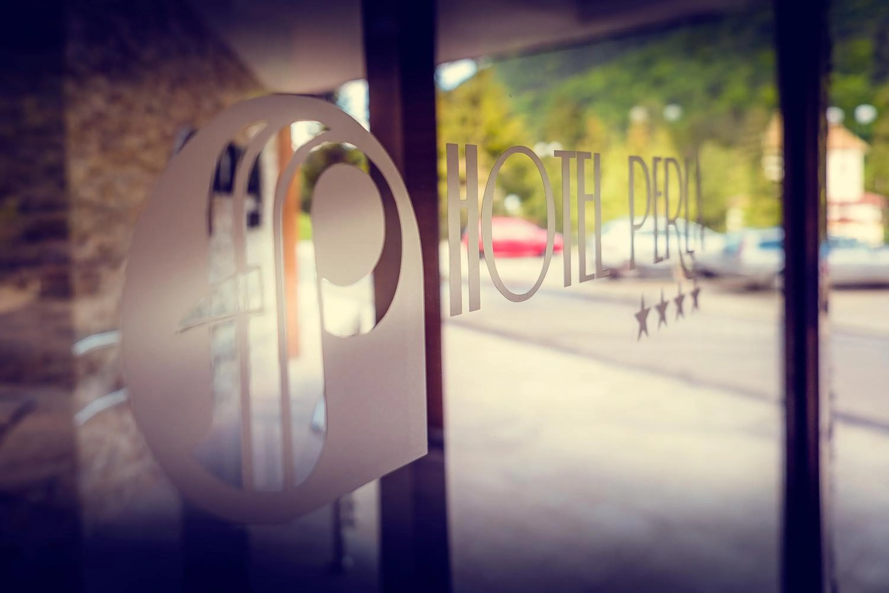 Property logo or sign in Hotel Perla