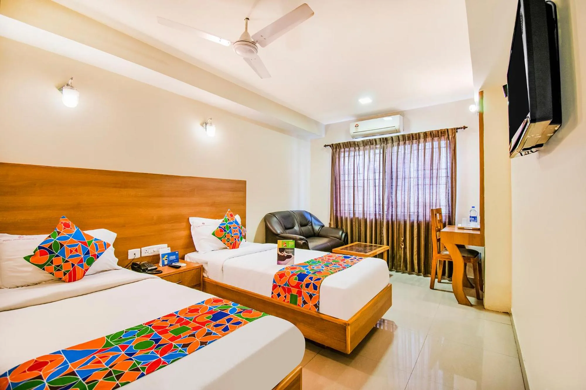 Bed in FabHotel Jansi Deluxe - Nr Gandhipuram Bus stand