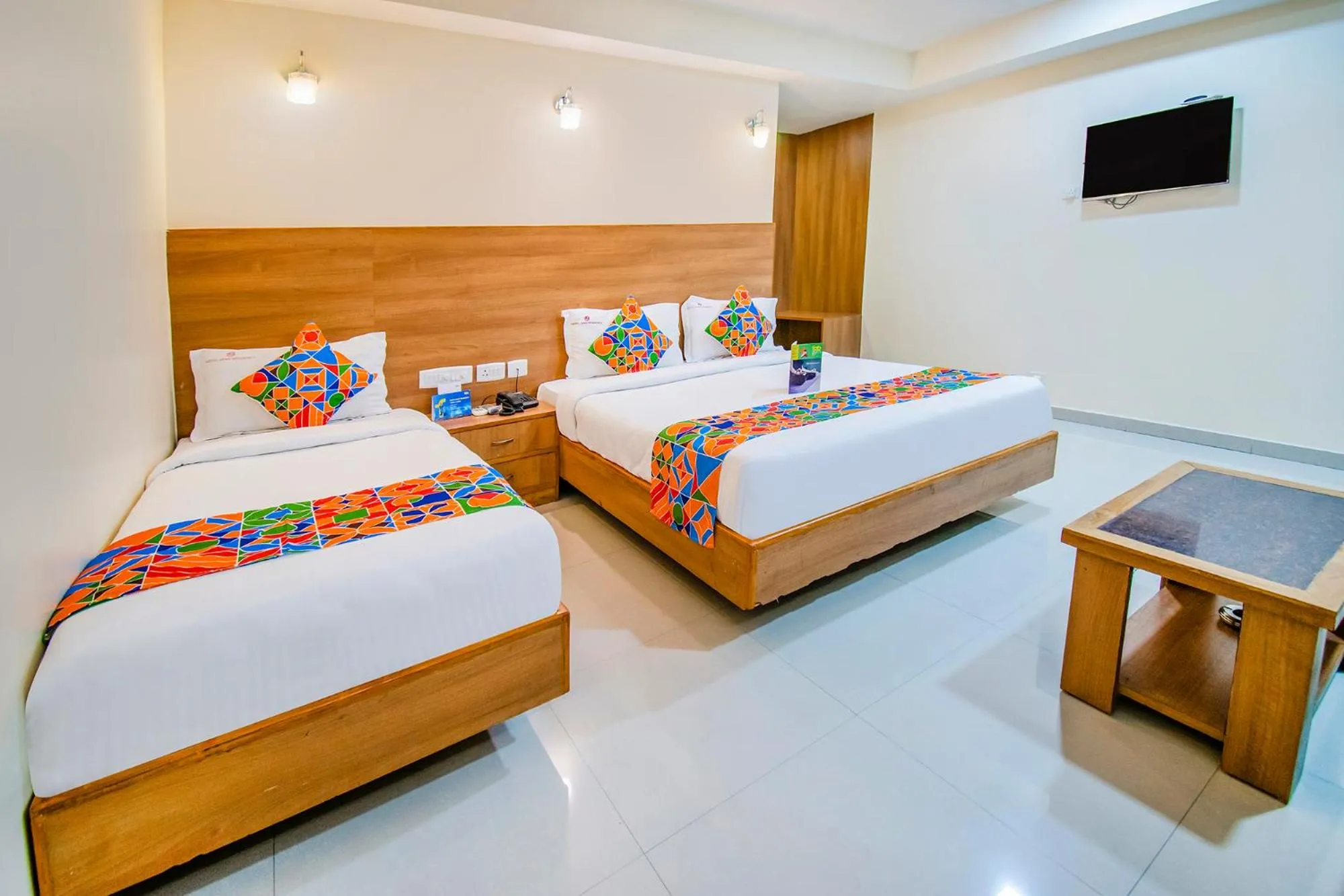 Bed in FabHotel Jansi Deluxe - Nr Gandhipuram Bus stand