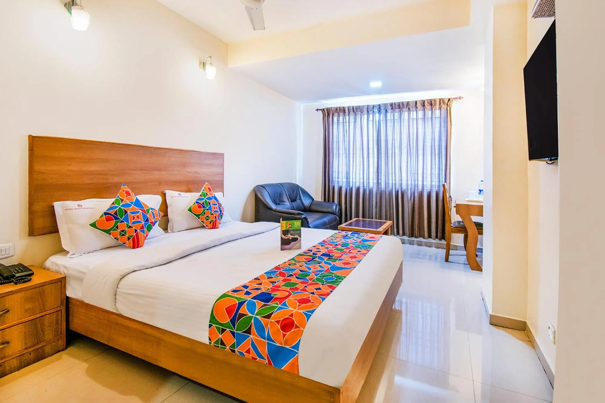 Bed in FabHotel Jansi Deluxe - Nr Gandhipuram Bus stand
