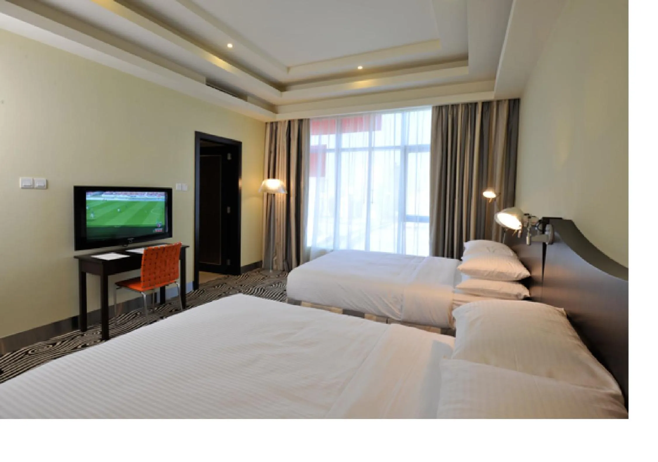 Bed in Al Raya Suites Hotel