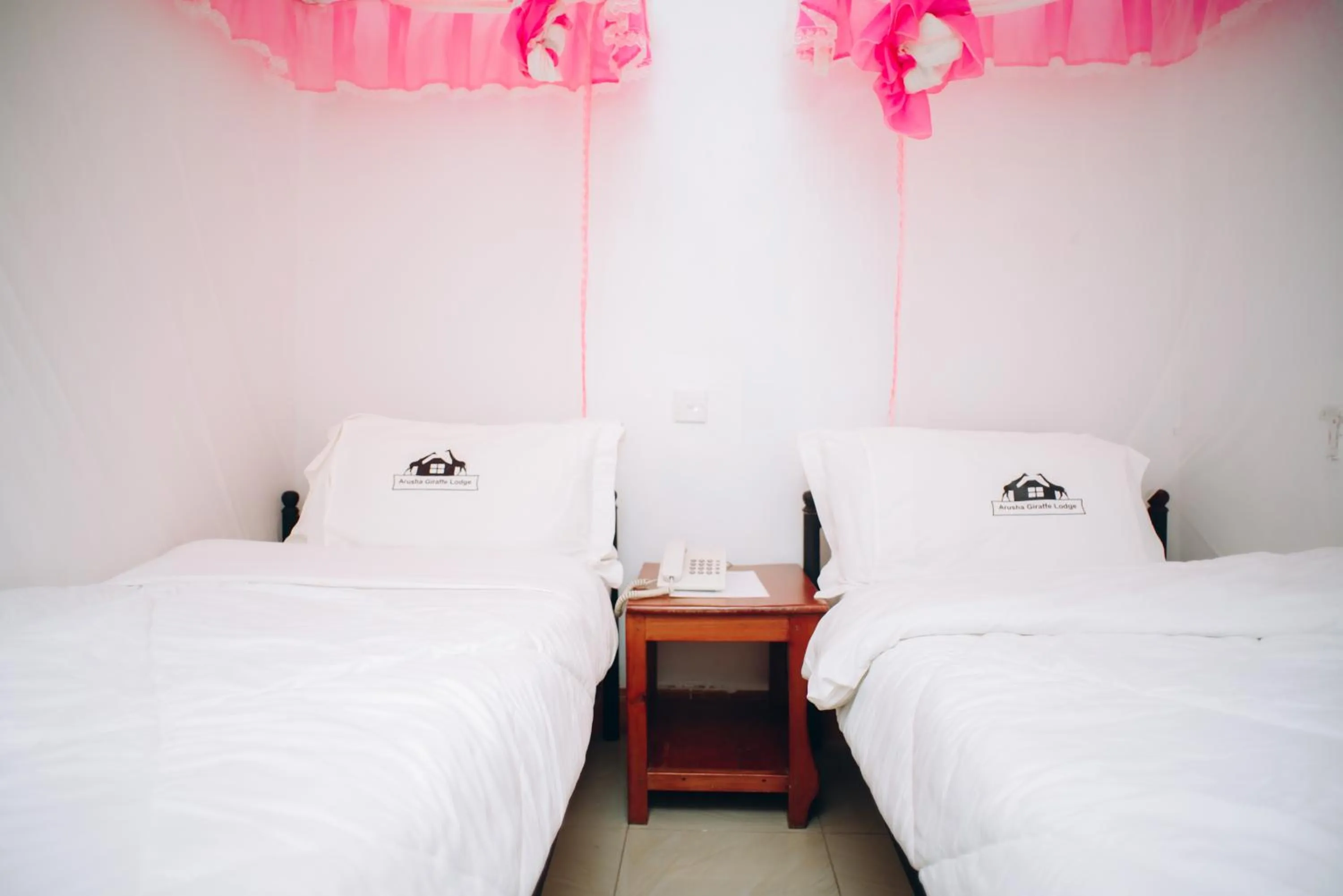 Bed in Arusha Giraffe Lodge