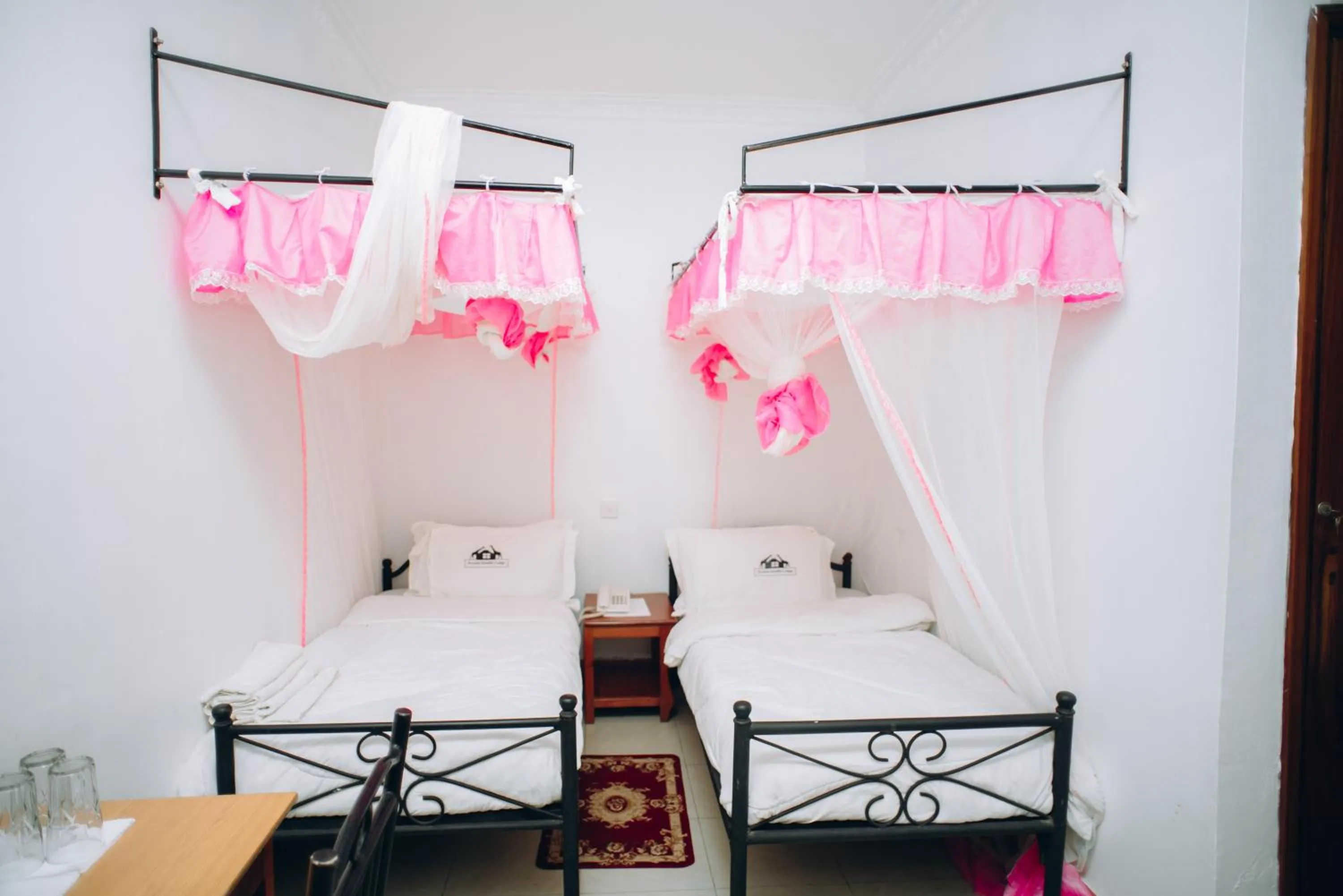 Bed in Arusha Giraffe Lodge