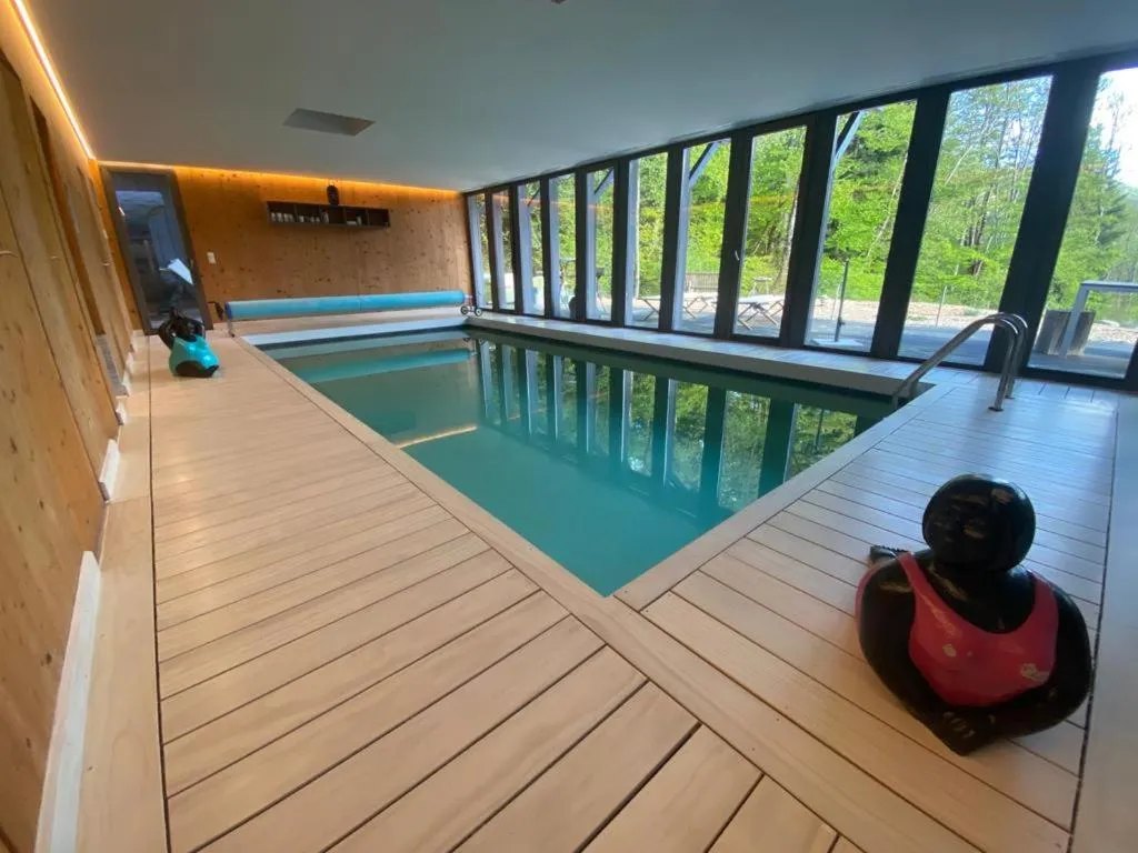 Swimming pool in Le Chalet Du Blanc Spa yoga