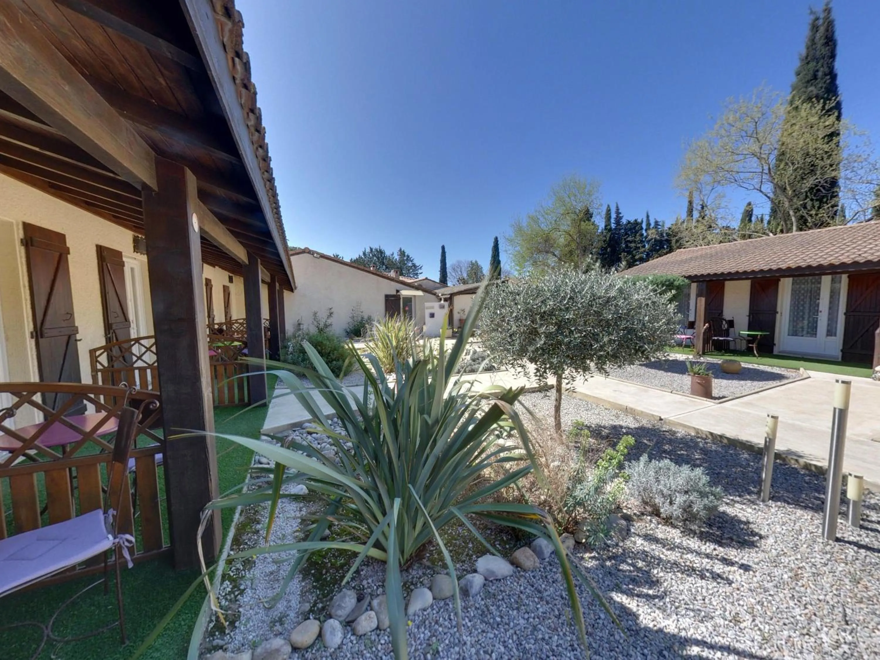 Garden in Logis Hotel Le Vieux Moulin