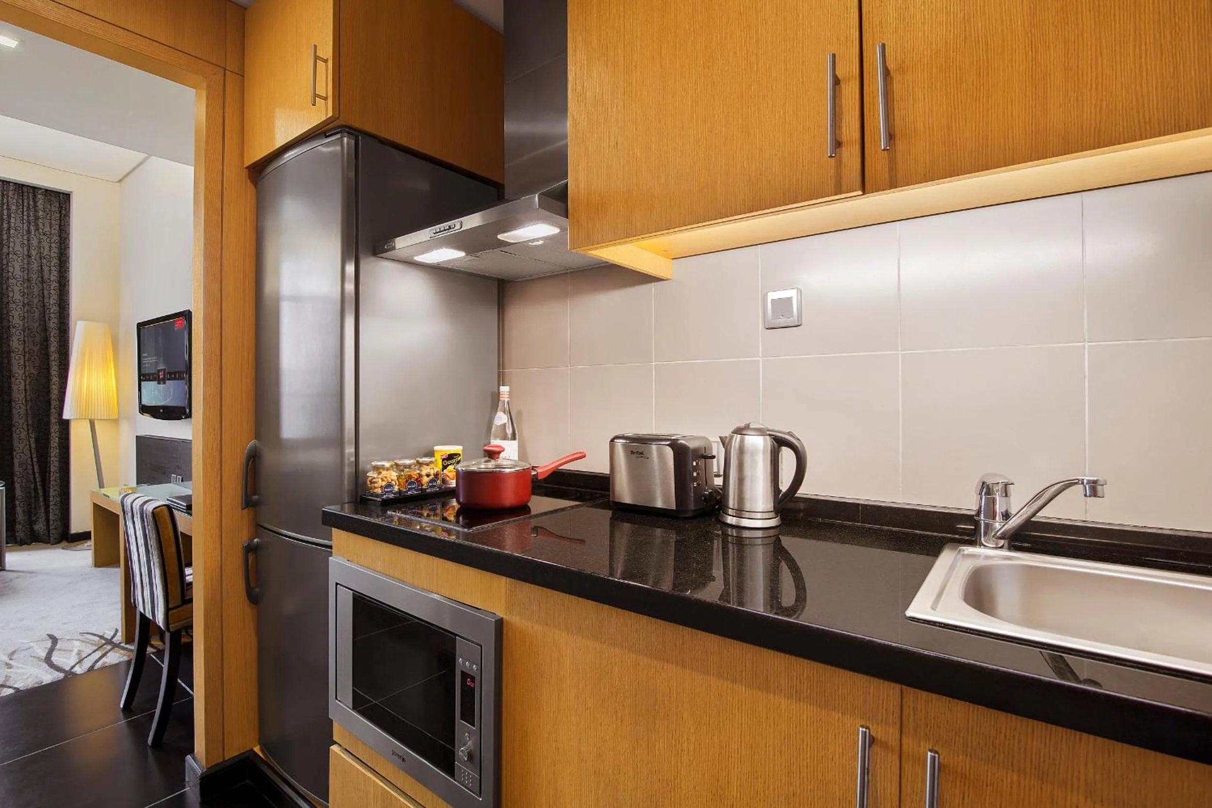 Kitchen or kitchenette in Hala Arjaan by Rotana, Deluxe Hotel Apartments