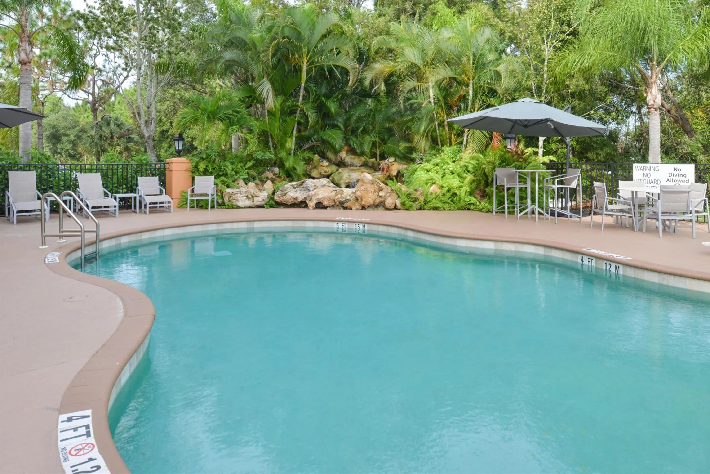 Swimming pool in Holiday Inn Express Hotel & Suites Bonita Springs/Naples by IHG