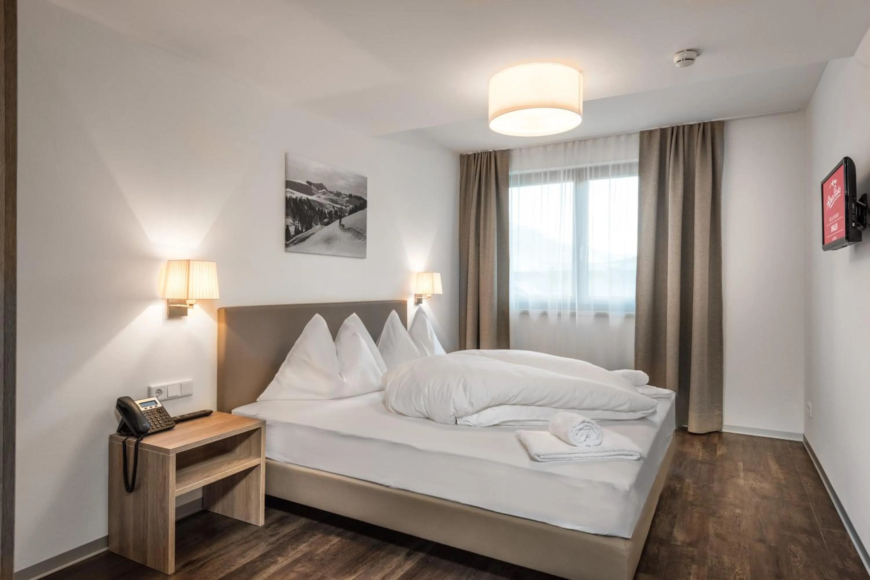Photo of the whole room, Bed in AlpenParks Hotel & Apartment Orgler Kaprun