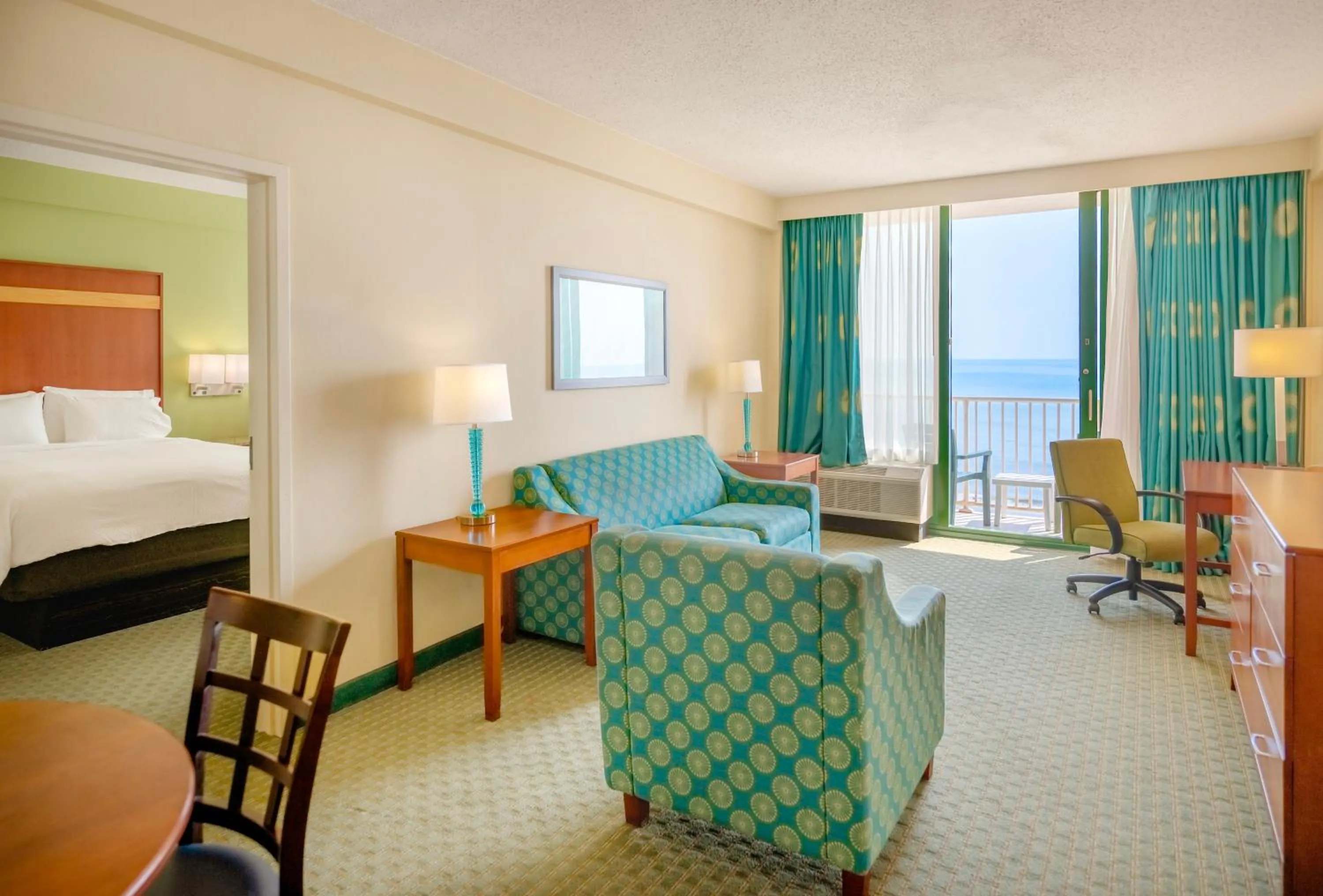 Living room, Bed in Holiday Inn & Suites Virginia Beach - North Beach by IHG
