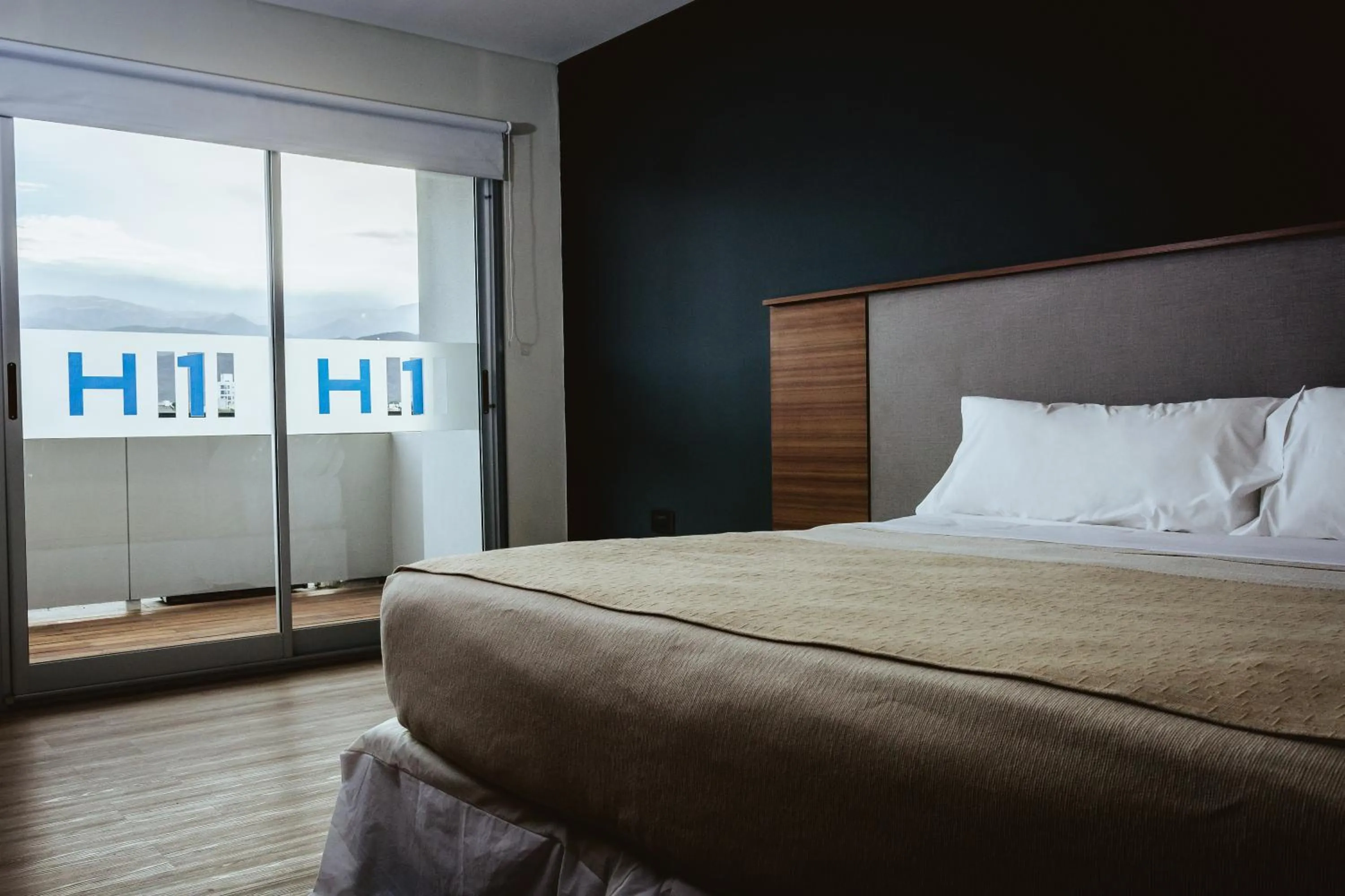 Bed in H1 Apartments Hotel