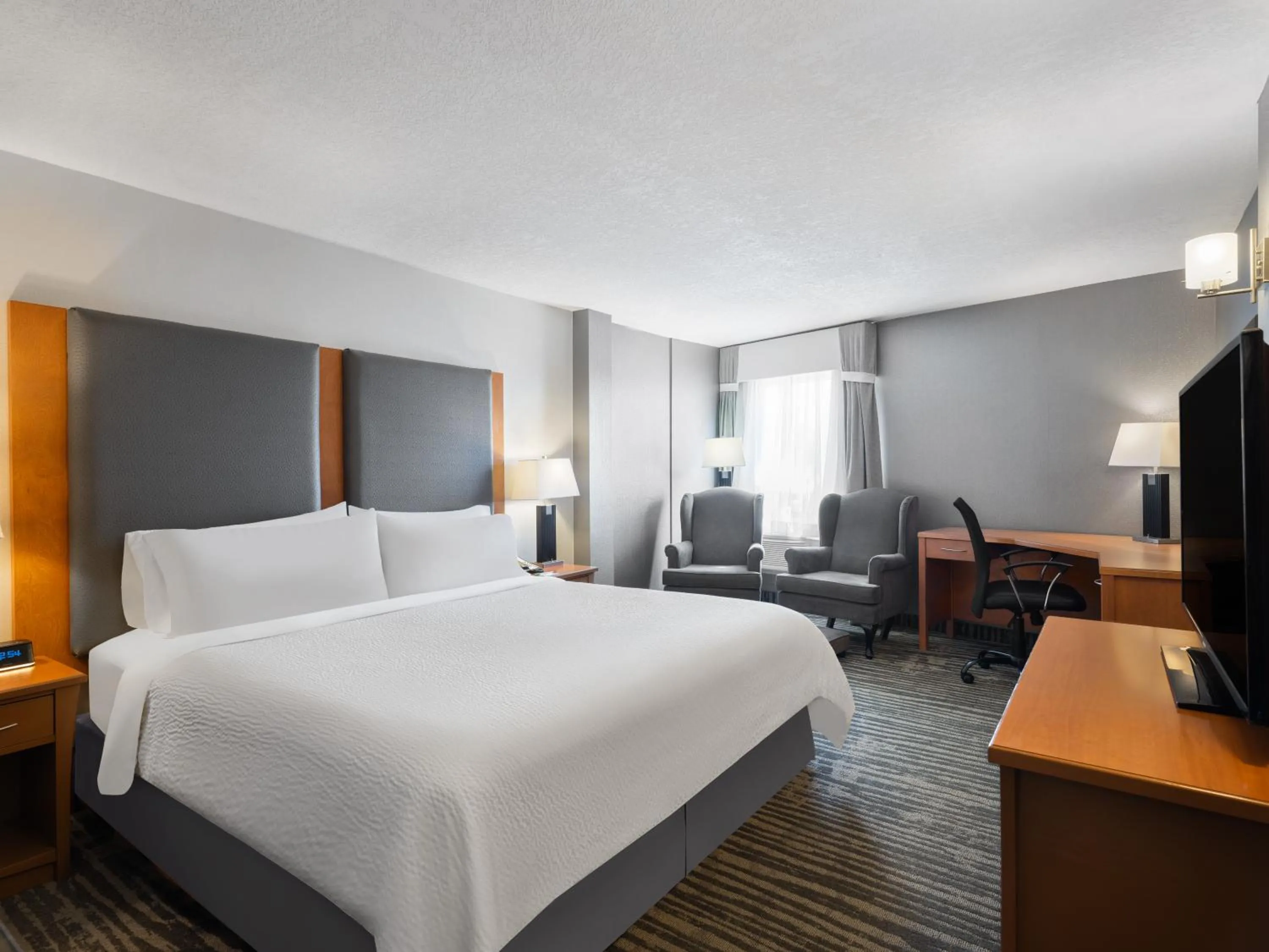 Seating area, Bed in Holiday Inn Calgary Airport by IHG