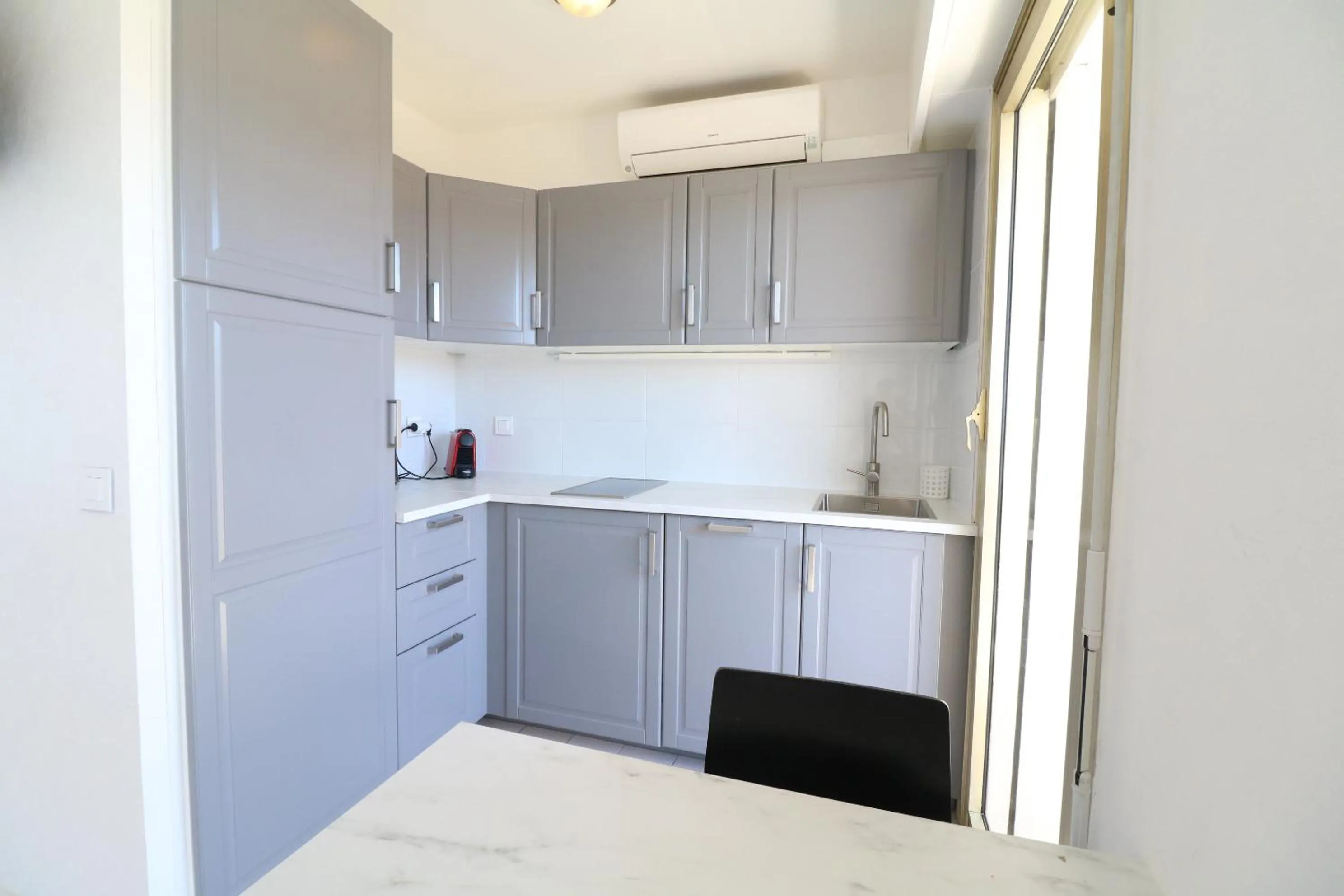 Kitchen or kitchenette in 2 bedroom & studio Palais Royal 2 mins from Croisette and Carlton