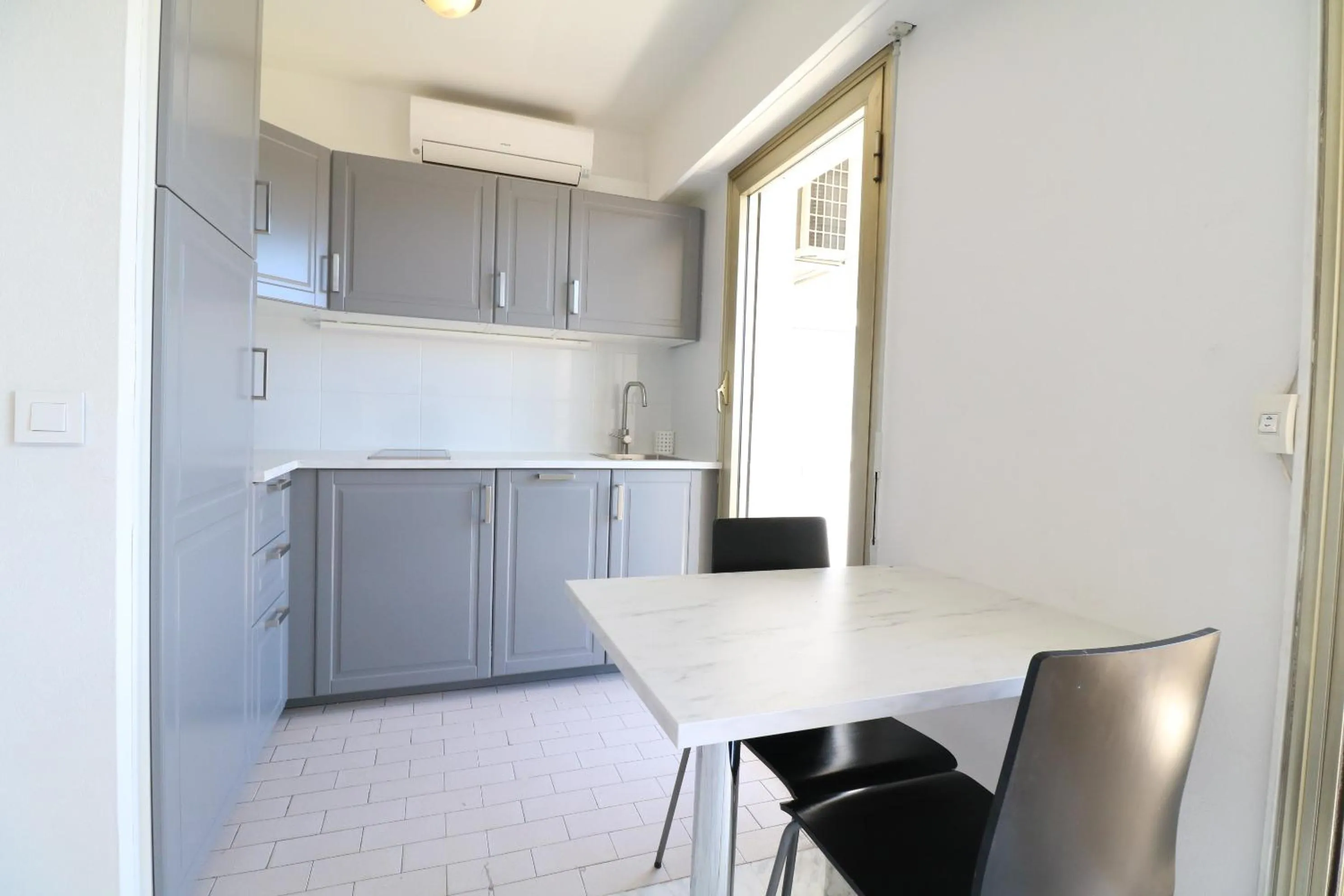 Kitchen or kitchenette in 2 bedroom & studio Palais Royal 2 mins from Croisette and Carlton