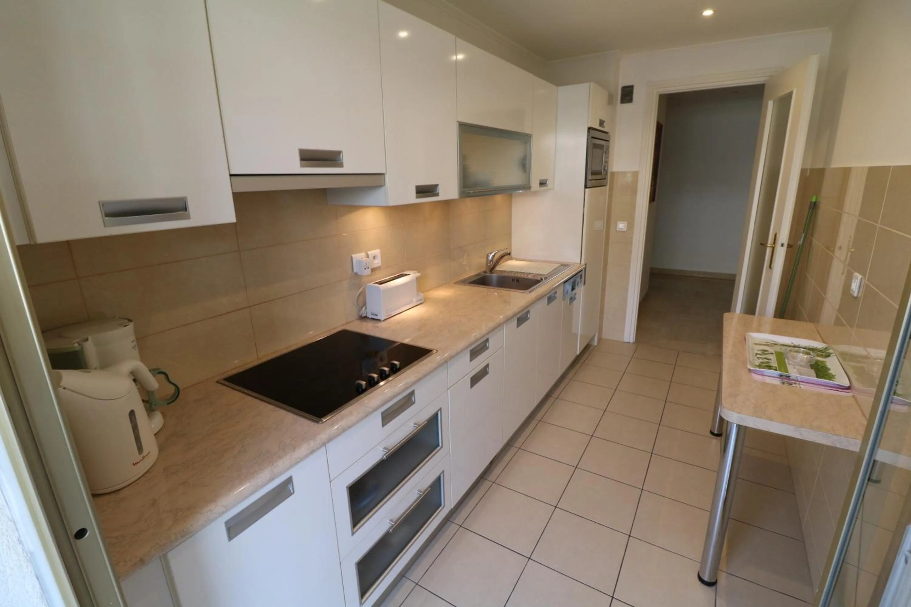 Kitchen or kitchenette in 2 bedroom & studio Palais Royal 2 mins from Croisette and Carlton