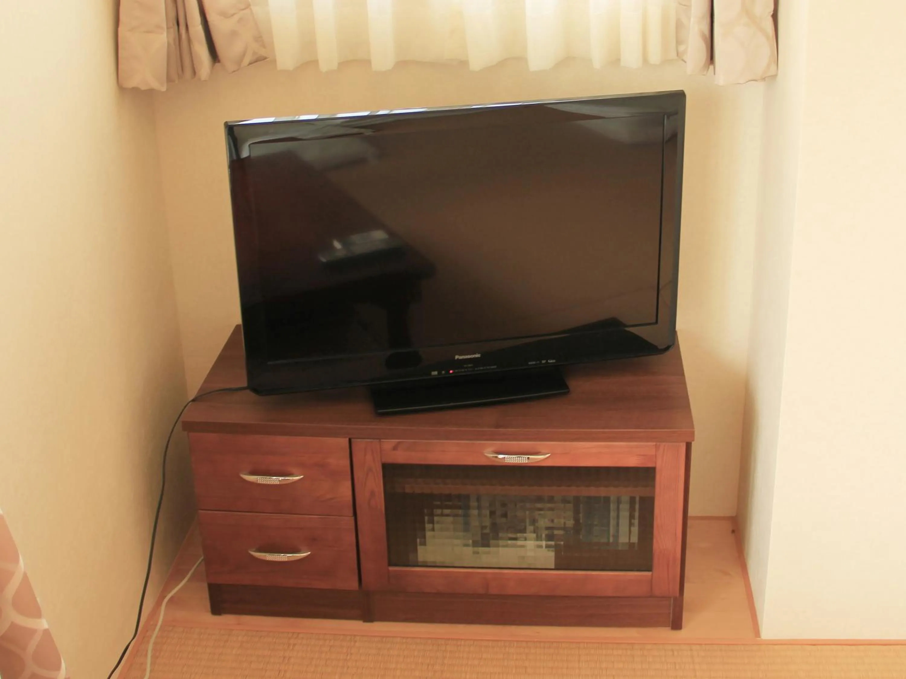 TV and multimedia in Kariyushi Condominium Ocean Hills Chouraku Stay