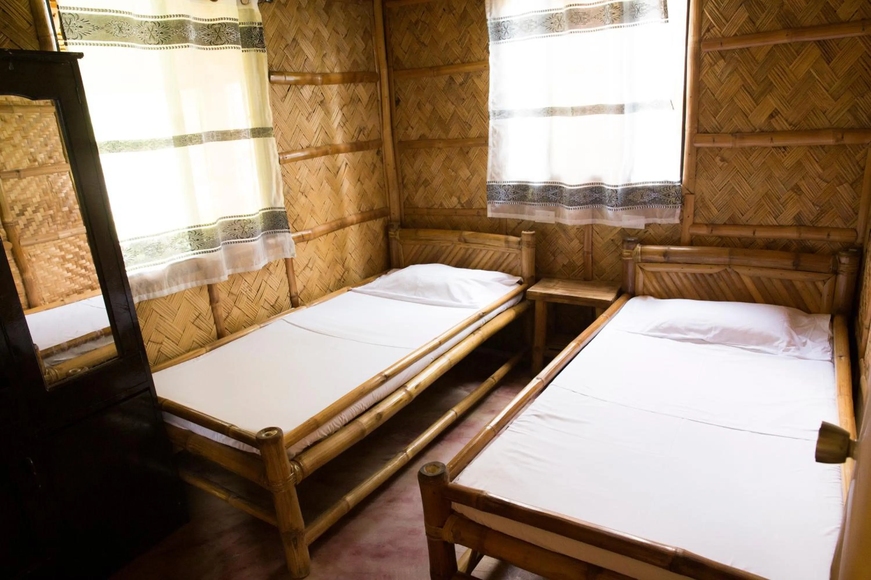 Bed in Calayo Beach Resort