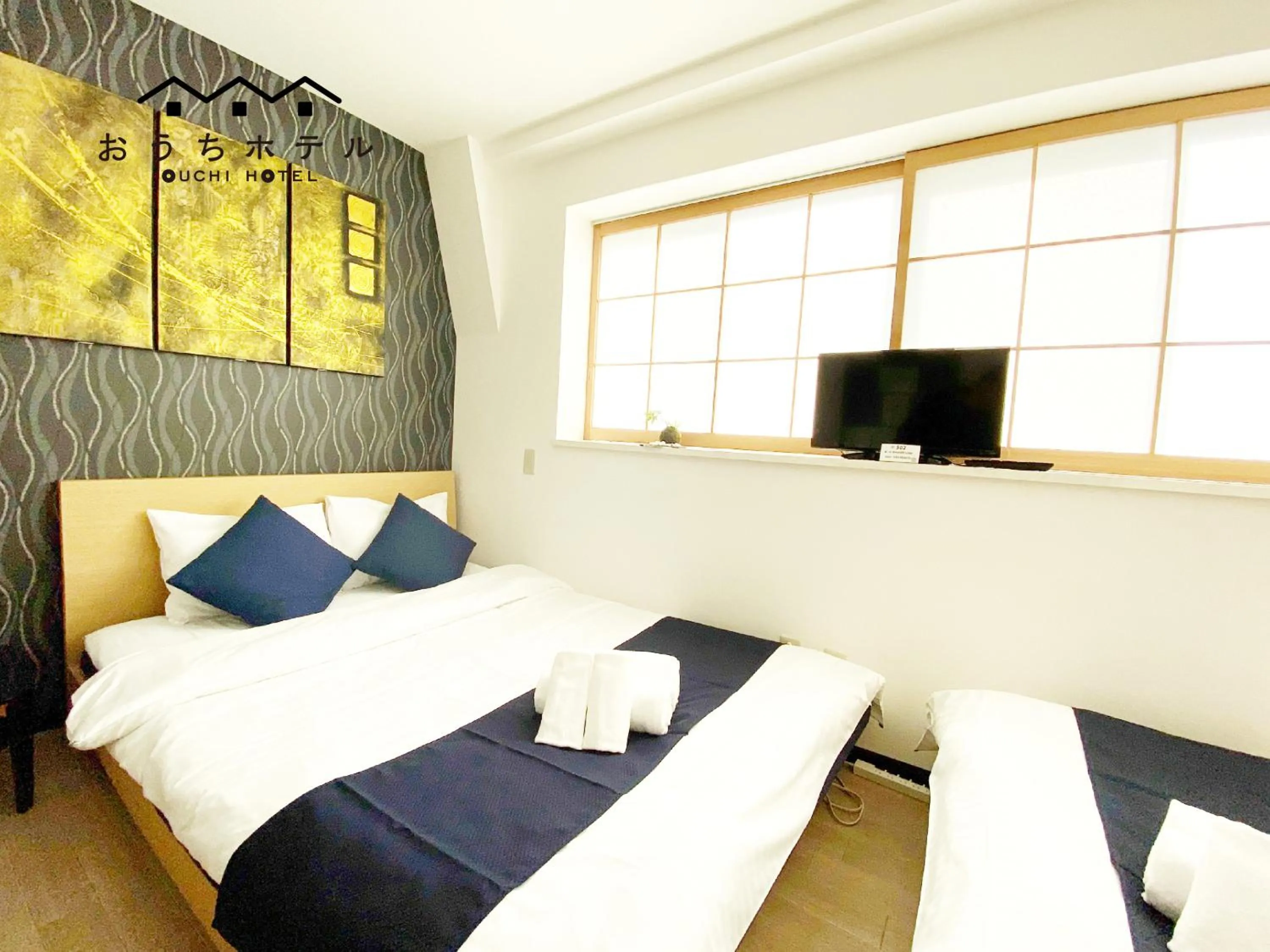 Bed in OUCHI HOTEL Yokogawa