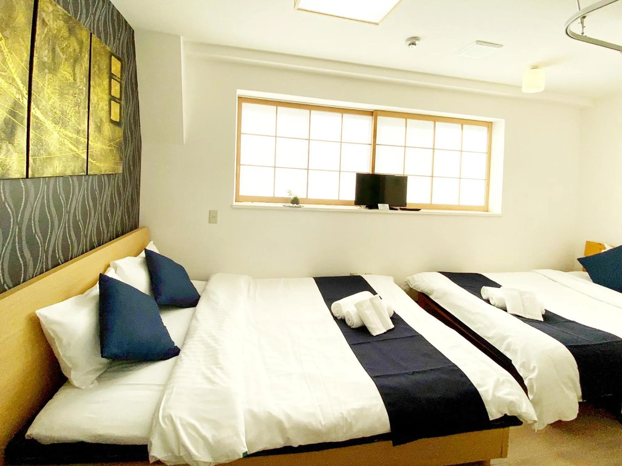 Bed in OUCHI HOTEL Yokogawa