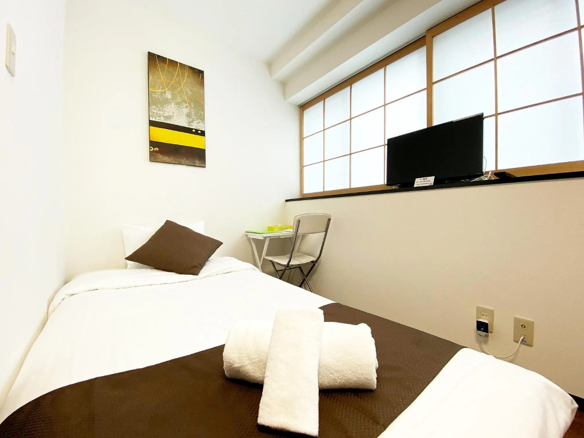 Bed in OUCHI HOTEL Yokogawa