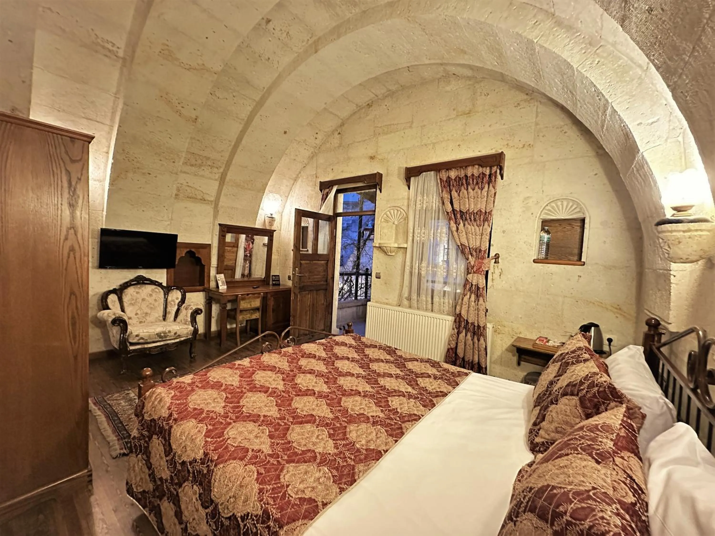 Bed in Stone House Cave Hotel