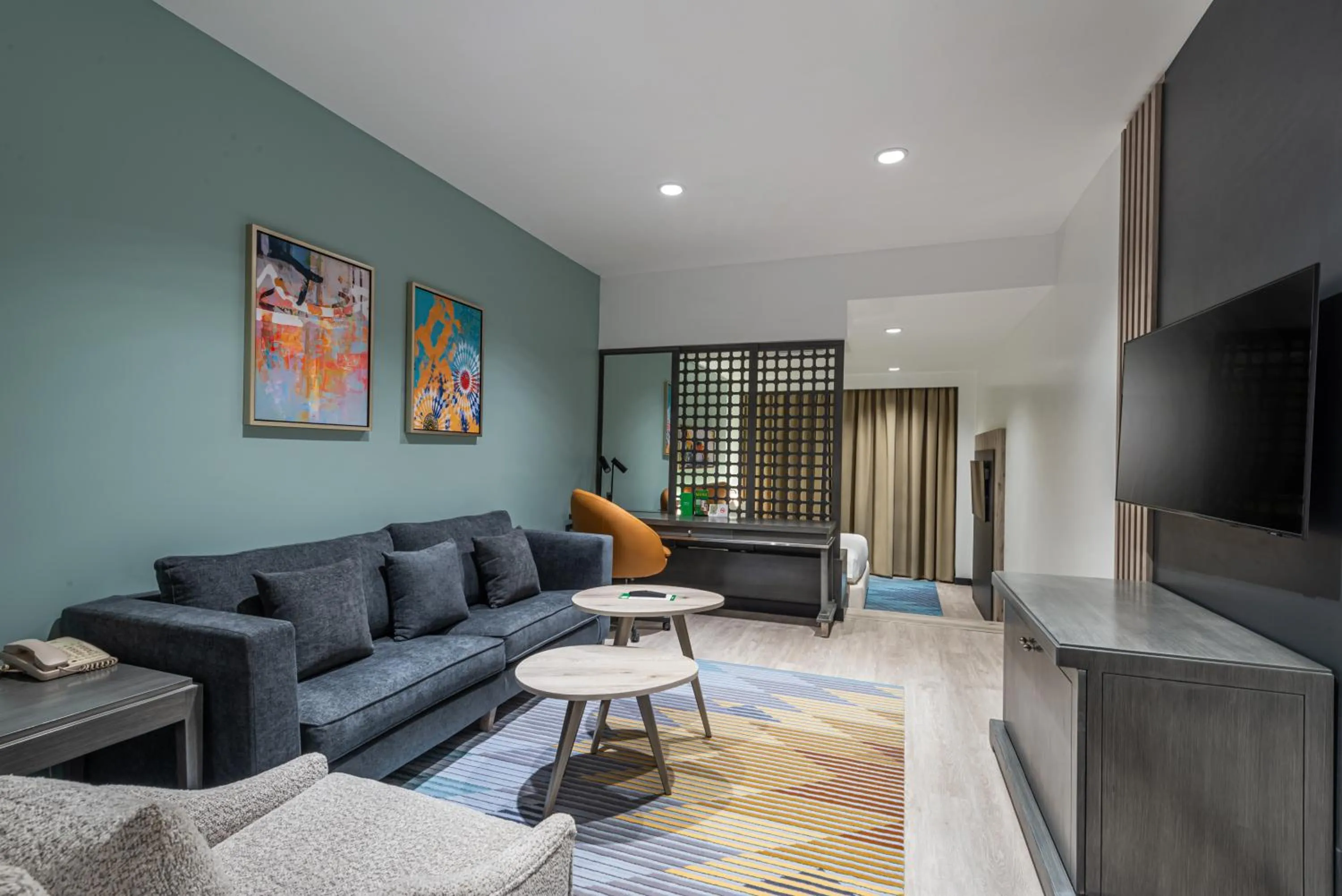 Communal lounge/ TV room in Holiday Inn Riyadh Al Qasr by IHG