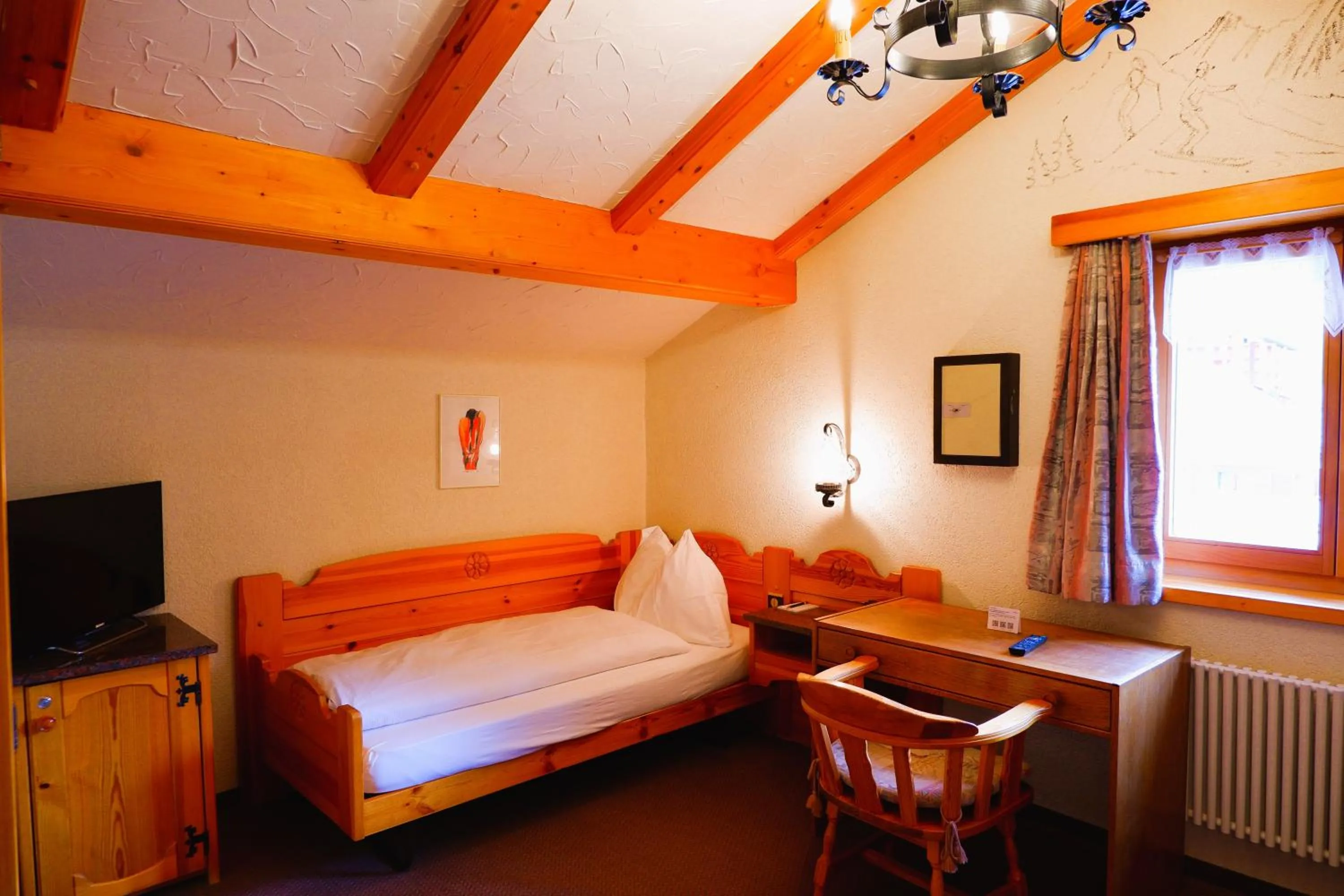 Bed in Hotel Christiania Saas-Fee