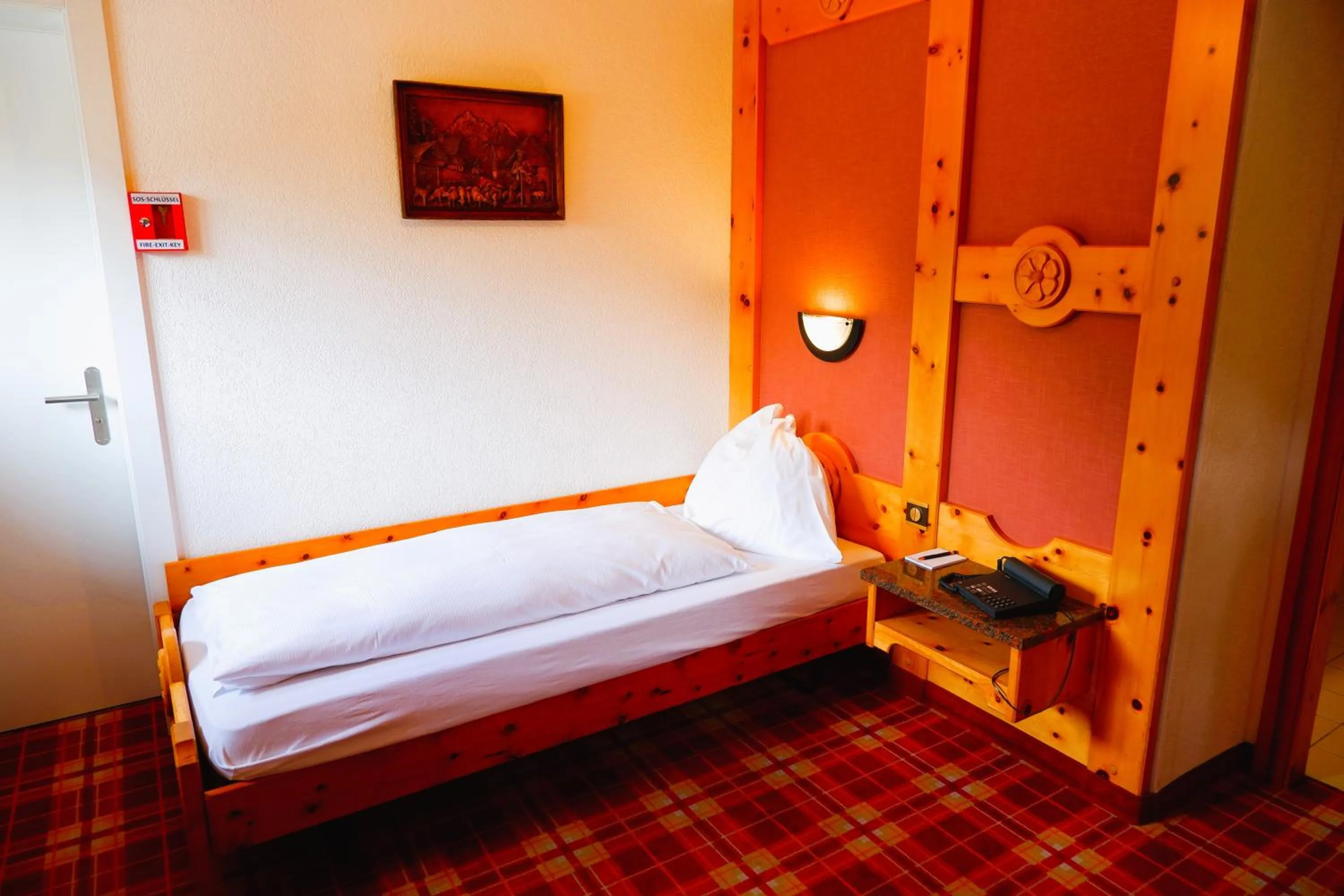 Bed in Hotel Christiania Saas-Fee