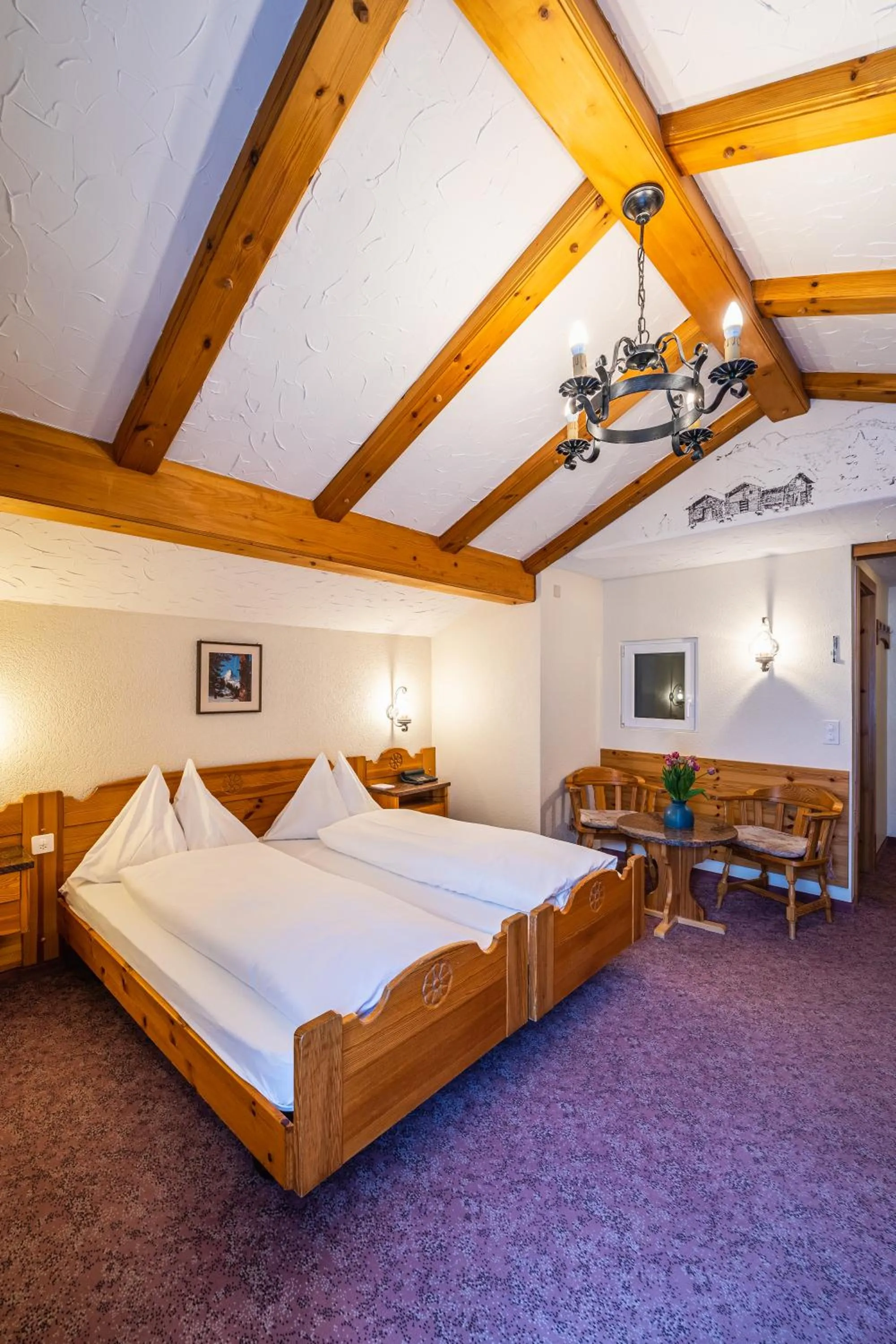 Bed in Hotel Christiania Saas-Fee