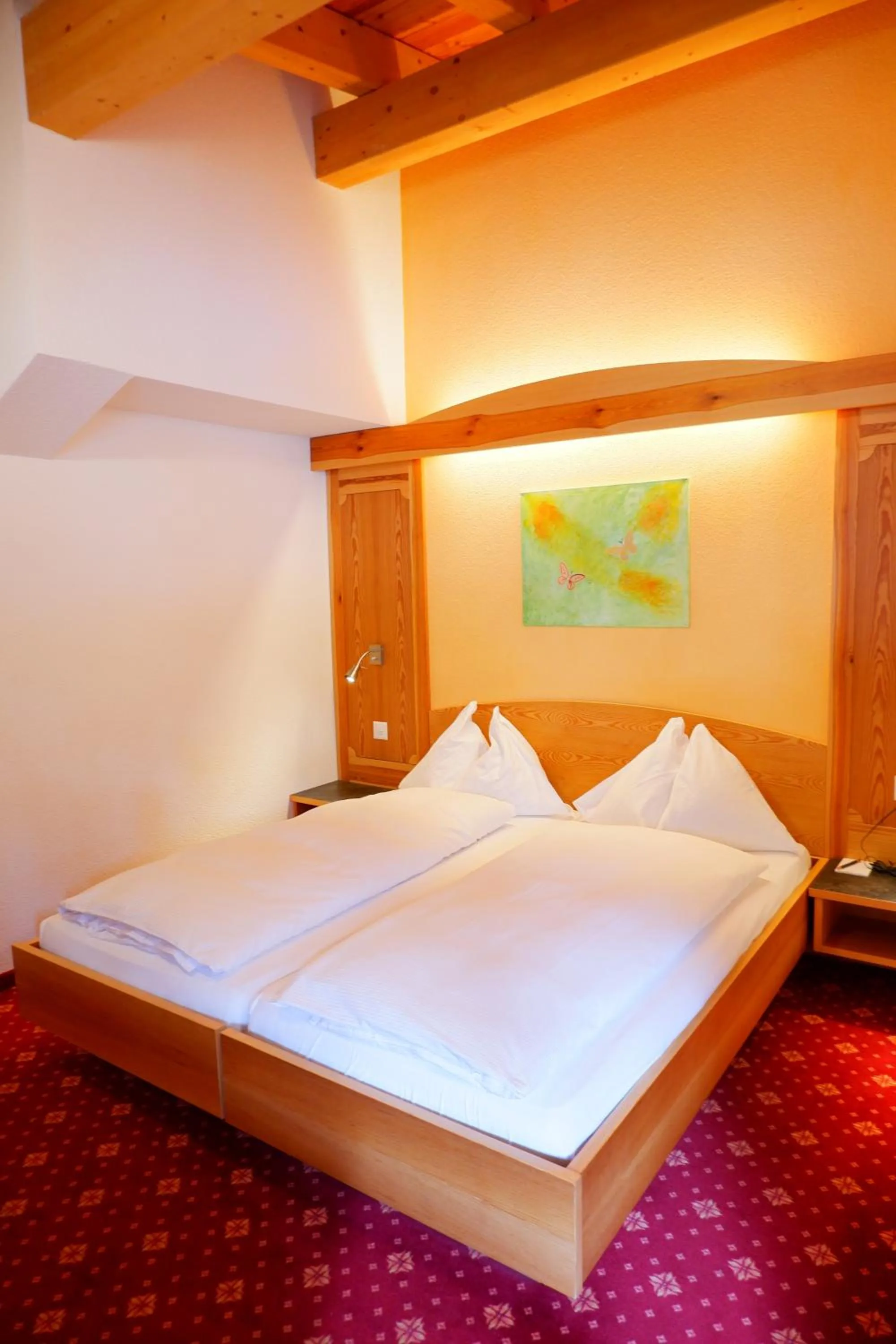 Bed in Hotel Christiania Saas-Fee