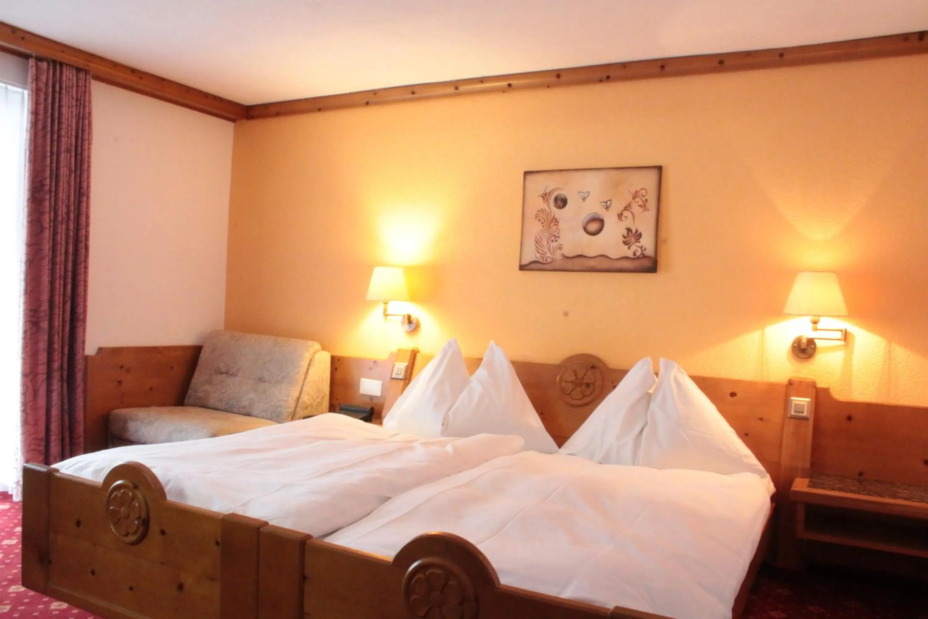 Bed in Hotel Christiania Saas-Fee