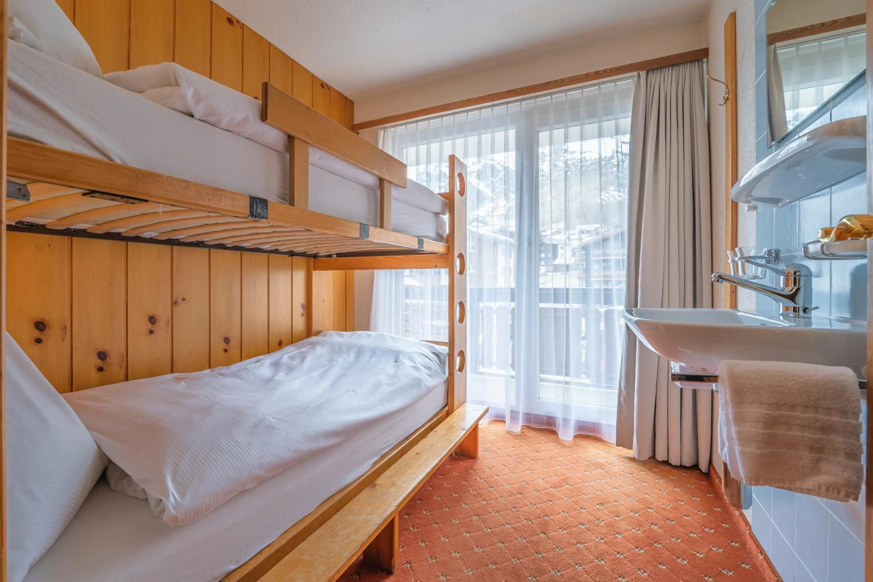 Bed in Hotel Christiania Saas-Fee