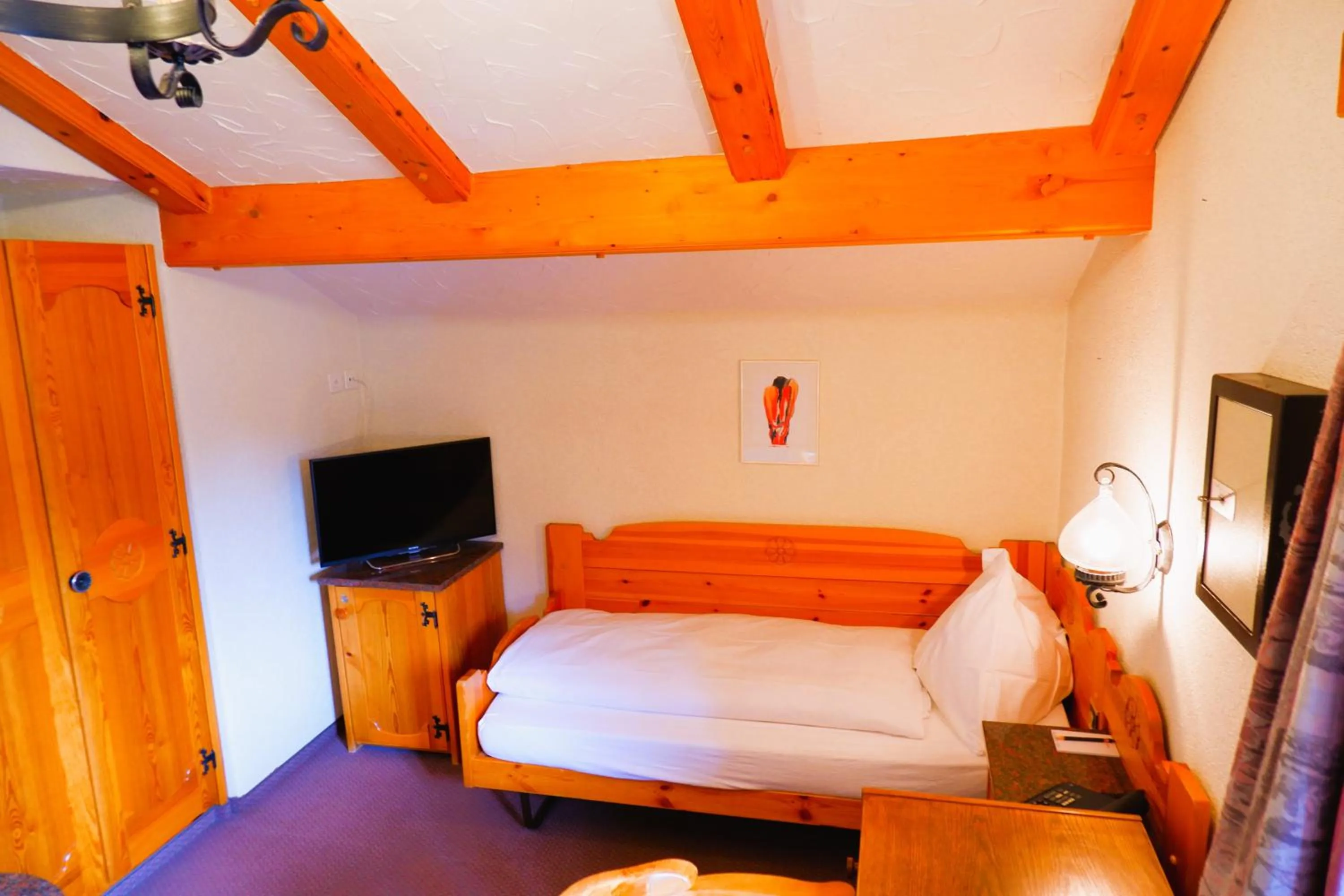 Bed in Hotel Christiania Saas-Fee