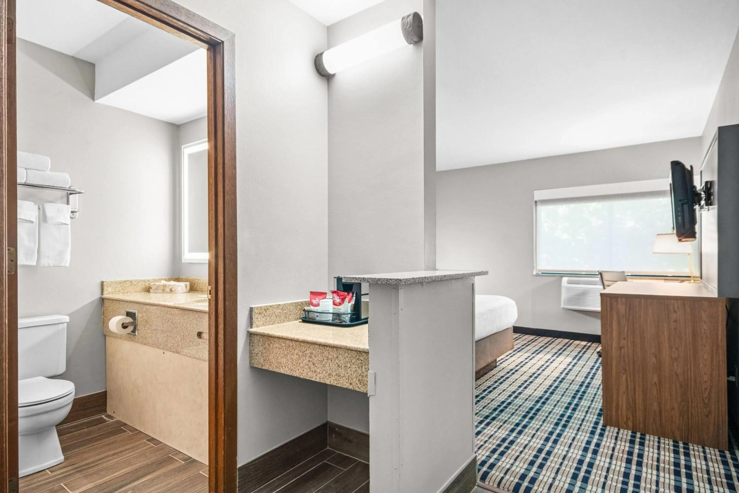 Bed in AmericInn by Wyndham Beloit