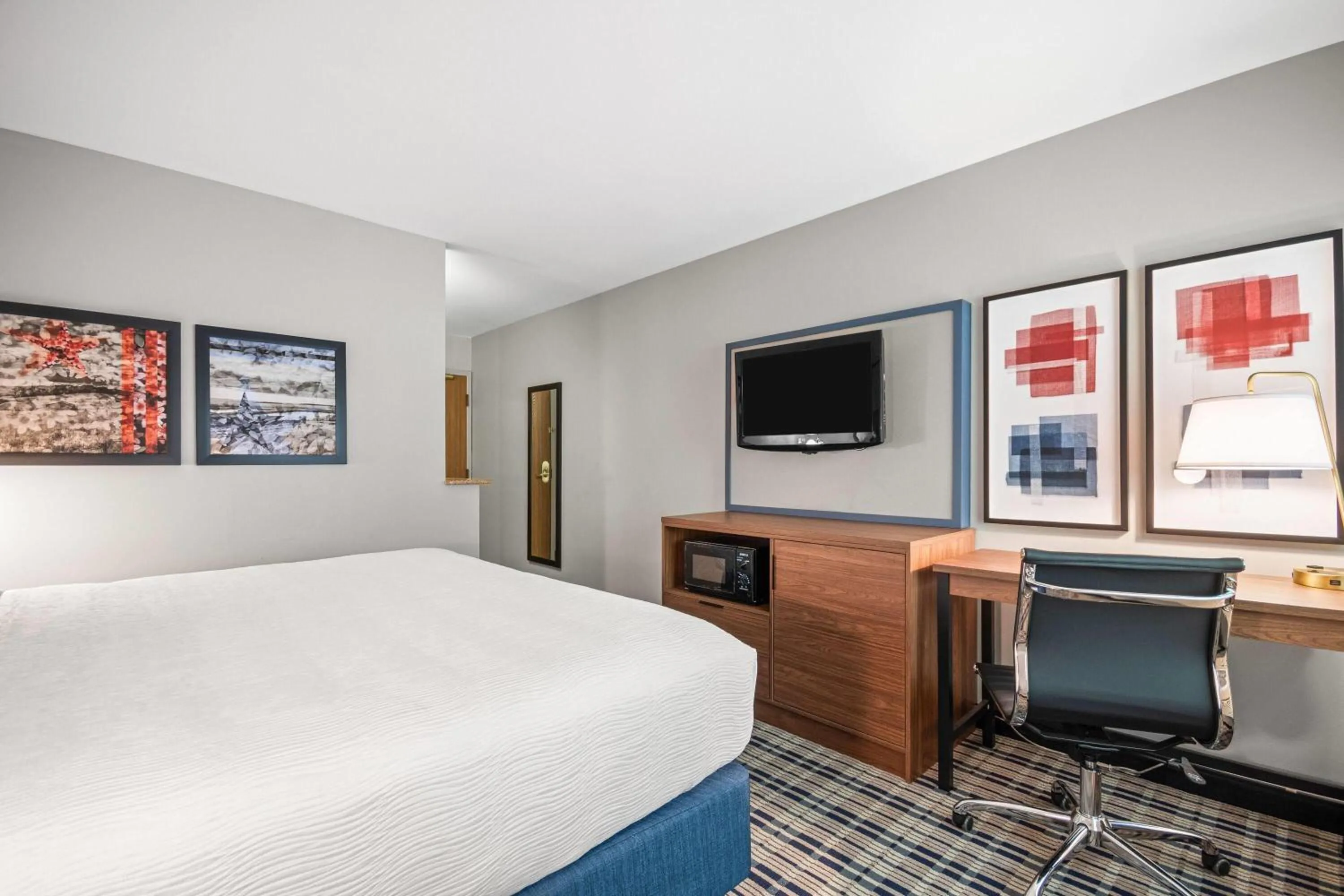 Bed in AmericInn by Wyndham Beloit